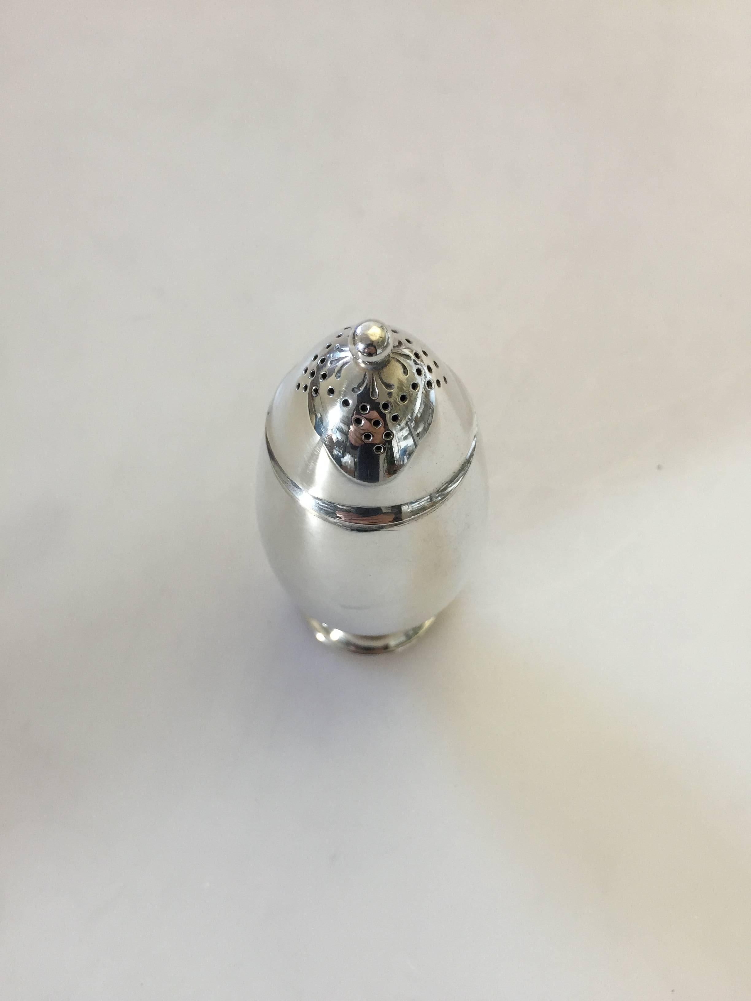 Georg Jensen sterling silver cactus salt shaker. Measures 5 cm high and is in perfect condition.

Georg Jensen (1866-1935) opened his small silver atelier in Copenhagen, Denmark in 1904. By 1935 the year of his death, he had received world acclaim