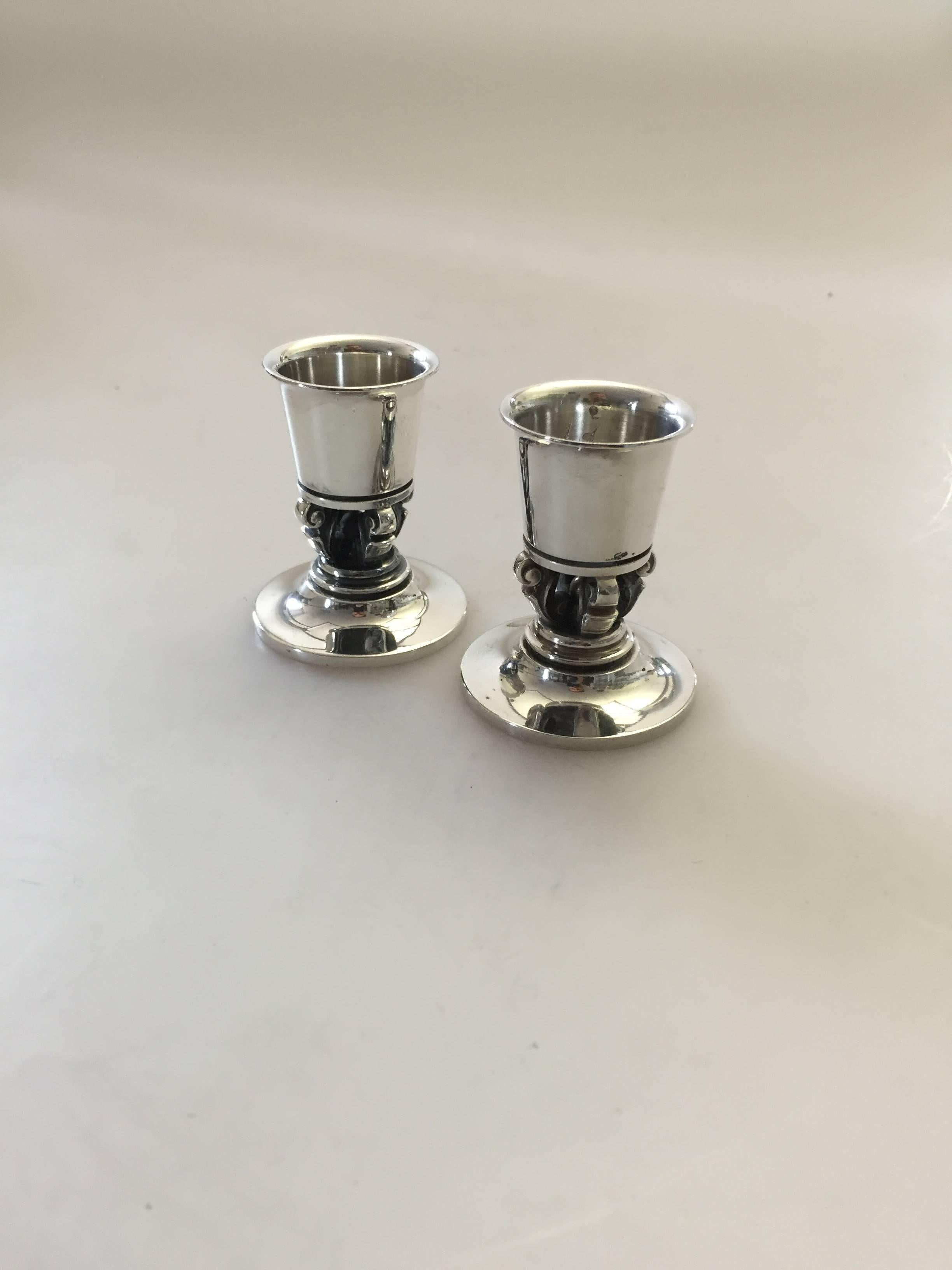Georg Jensen sterling silver pair of acorn candlesticks #741. The candlesticks are 5.3 cm high and in a good condition. We have several pairs in stock most of them with old marks. 

Georg Jensen (1866-1935) opened his small silver atelier in