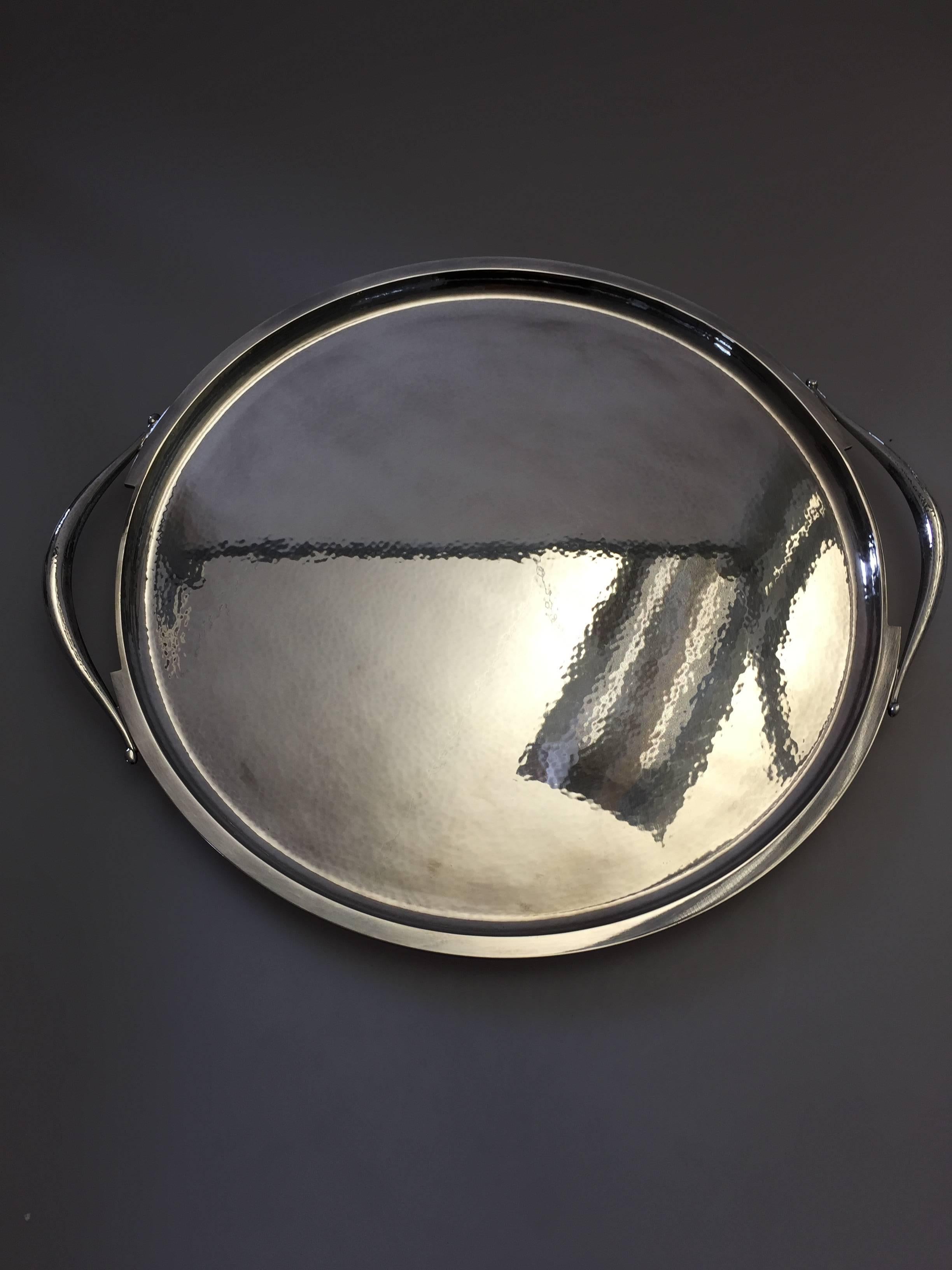 Georg Jensen sterling silver tray with handles #847A designed by Harald Nielsen. The tray measures 38 cm in diameter and is in a good condition. 

Georg Jensen (1866-1935) opened his small silver atelier in Copenhagen, Denmark in 1904. By 1935 the