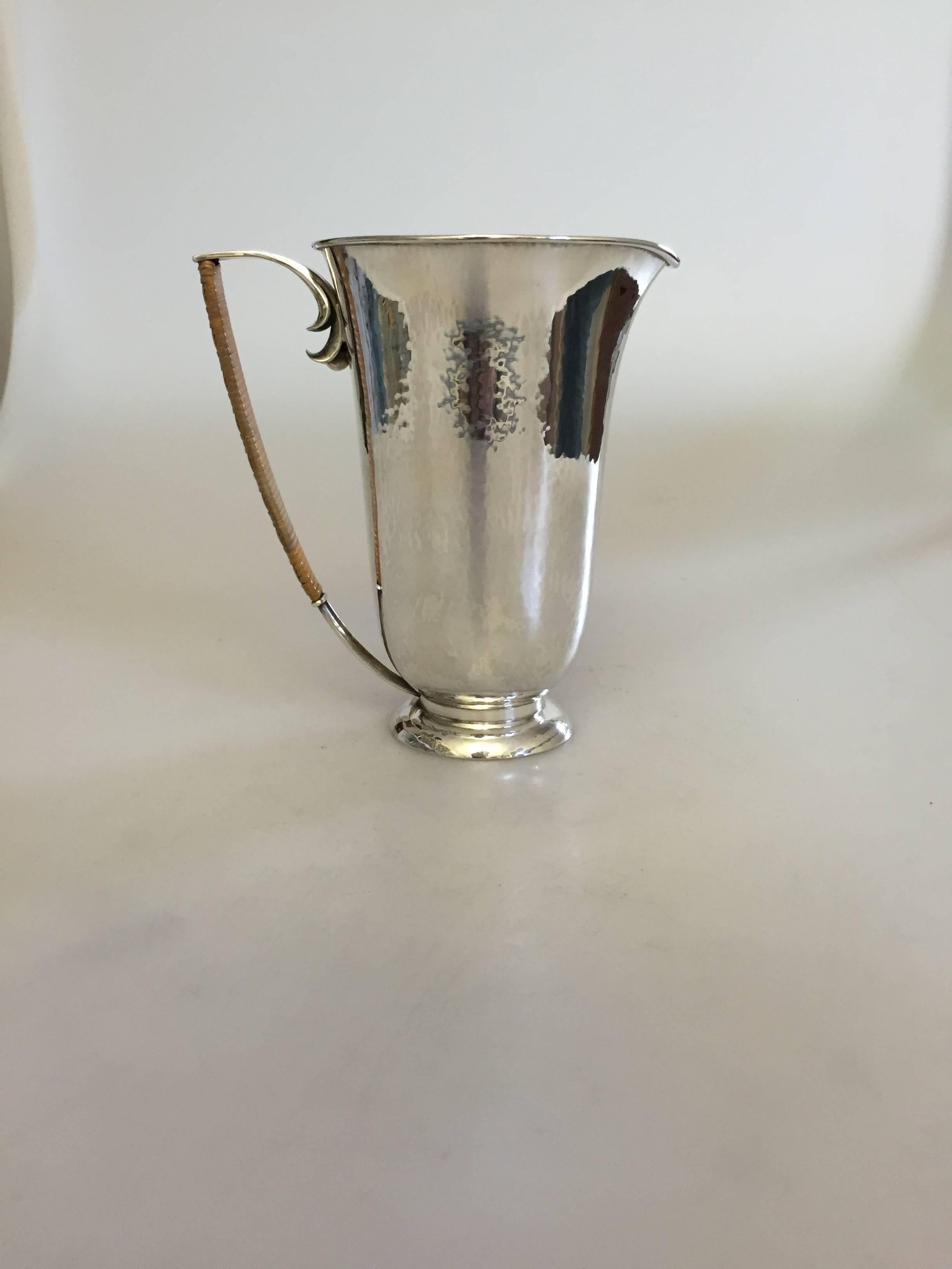 Hans Hansen sterling silver pitcher by Karl Gustav Hansen from 1933. The pitcher measures 15 cm high and is in a good condition.

Hans Hansen (1884-1940) was a Danish silversmithy. He opened his own smithy and shop in Kolding, Denmark in 1906.