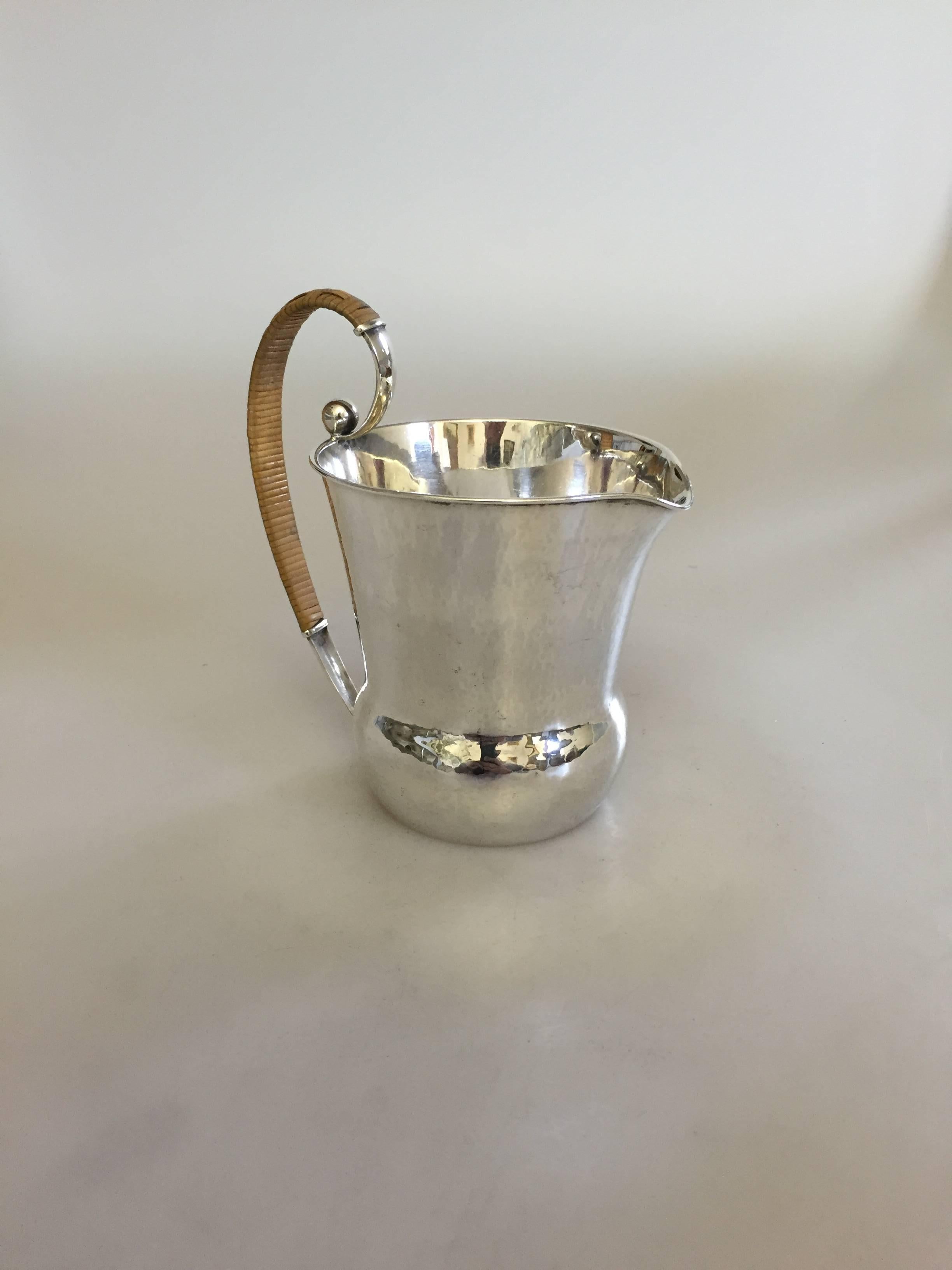 Hans Hansen sterling silver pitcher #217 designed by Karl Gustav Hansen. The pitcher is from 1937 and is in perfect condition. It measures 14.5 cm high. 

Hans Hansen (1884-1940) was a Danish silversmithy. He opened his own smithy and shop in