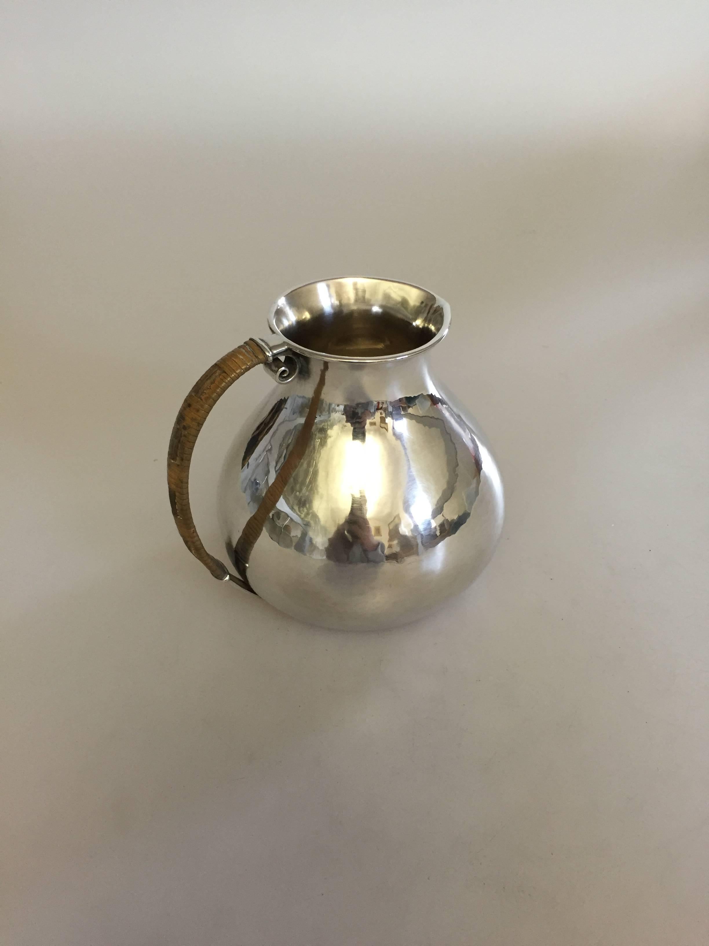 Hans Hansen sterling silver pitcher by Karl Gustav Hansen from 1932. The pitcher measures 10.5 cm and is in good condition.

Hans Hansen (1884-1940) was a Danish silversmithy. He opened his own smithy and shop in Kolding, Denmark in 1906. Starting