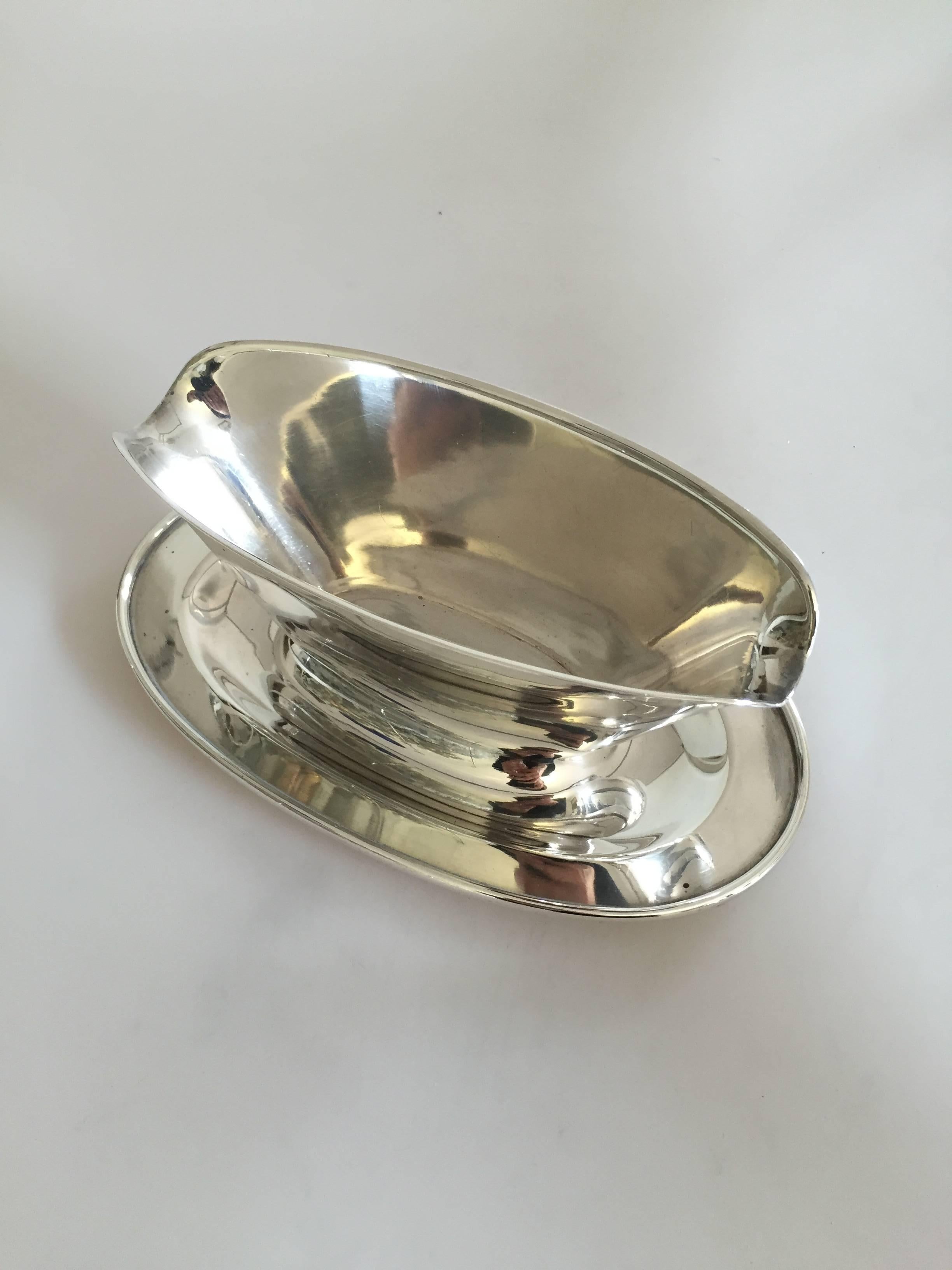 Hans Hansen Sterling silver sauce bowl by Karl Gustav Hansen. Measures 23 cm long and 9 cm high. In good condition. Made first time in 1944.

Hans Hansen (1884-1940) was a Danish silversmithy. He opened his own smithy and shop in Kolding, Denmark