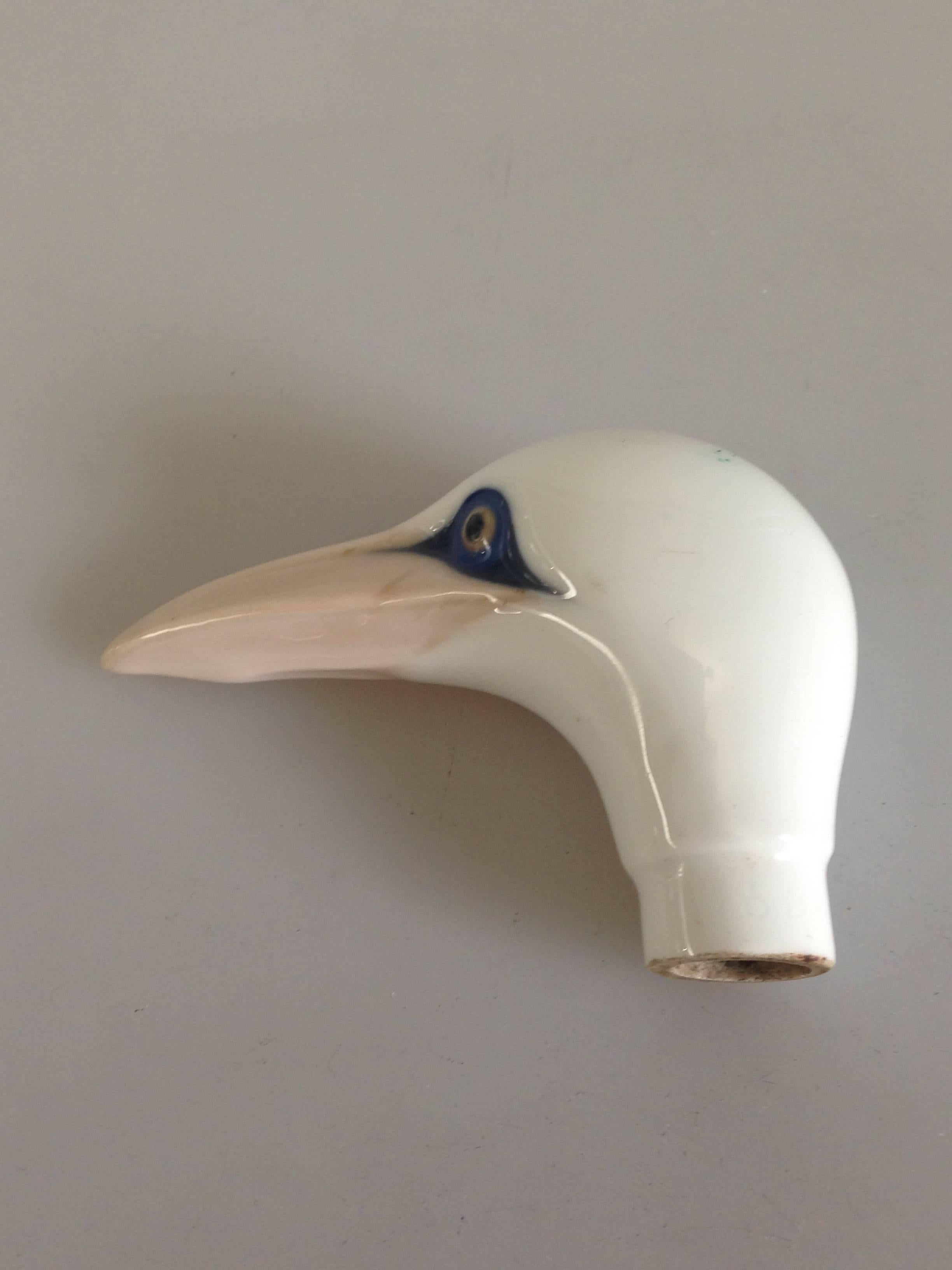 Royal Copenhagen Canehandle as a bird #428. Has a hairline crack, but otherwise perfect.

Royal Copenhagen, officially the Royal Porcelain Factory (Danish: Den Kongelige Porcelænsfabrik), is a manufacturer of porcelain products and was founded in