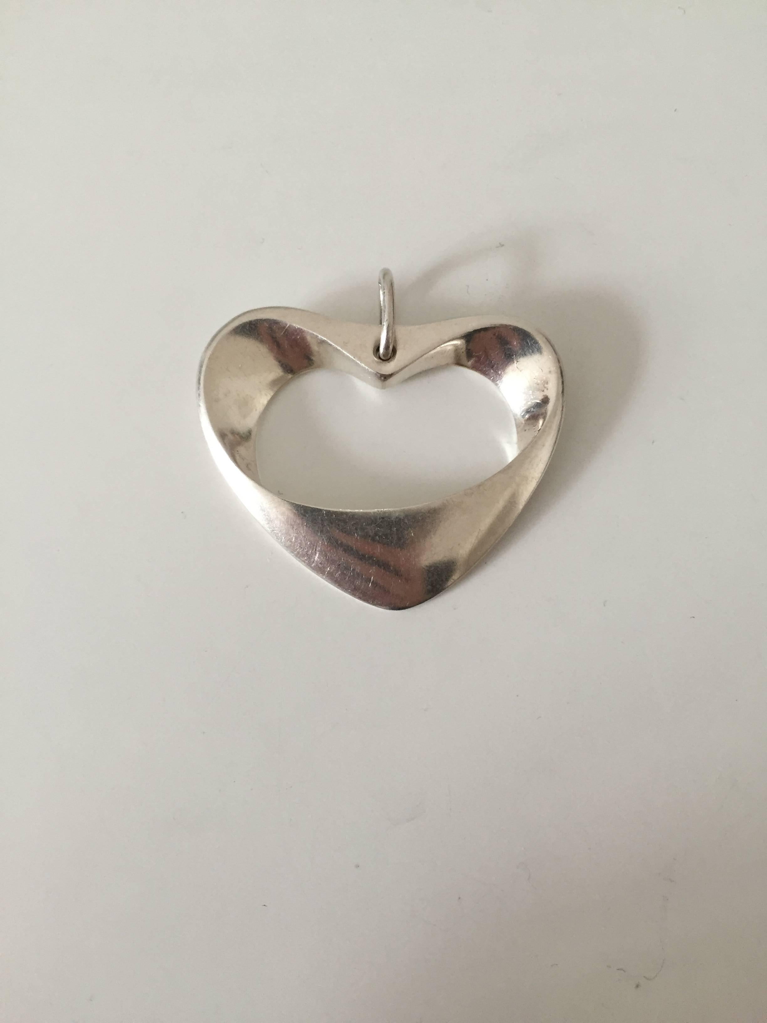 Large Georg Jensen sterling silver heart pendant #152. 

Measures 5 cm x 4 cm.
Weighs 21.7 g/0.76 oz.

Georg Jensen (1866-1935) opened his small silver atelier in Copenhagen, Denmark in 1904. By 1935 the year of his death, he had received world