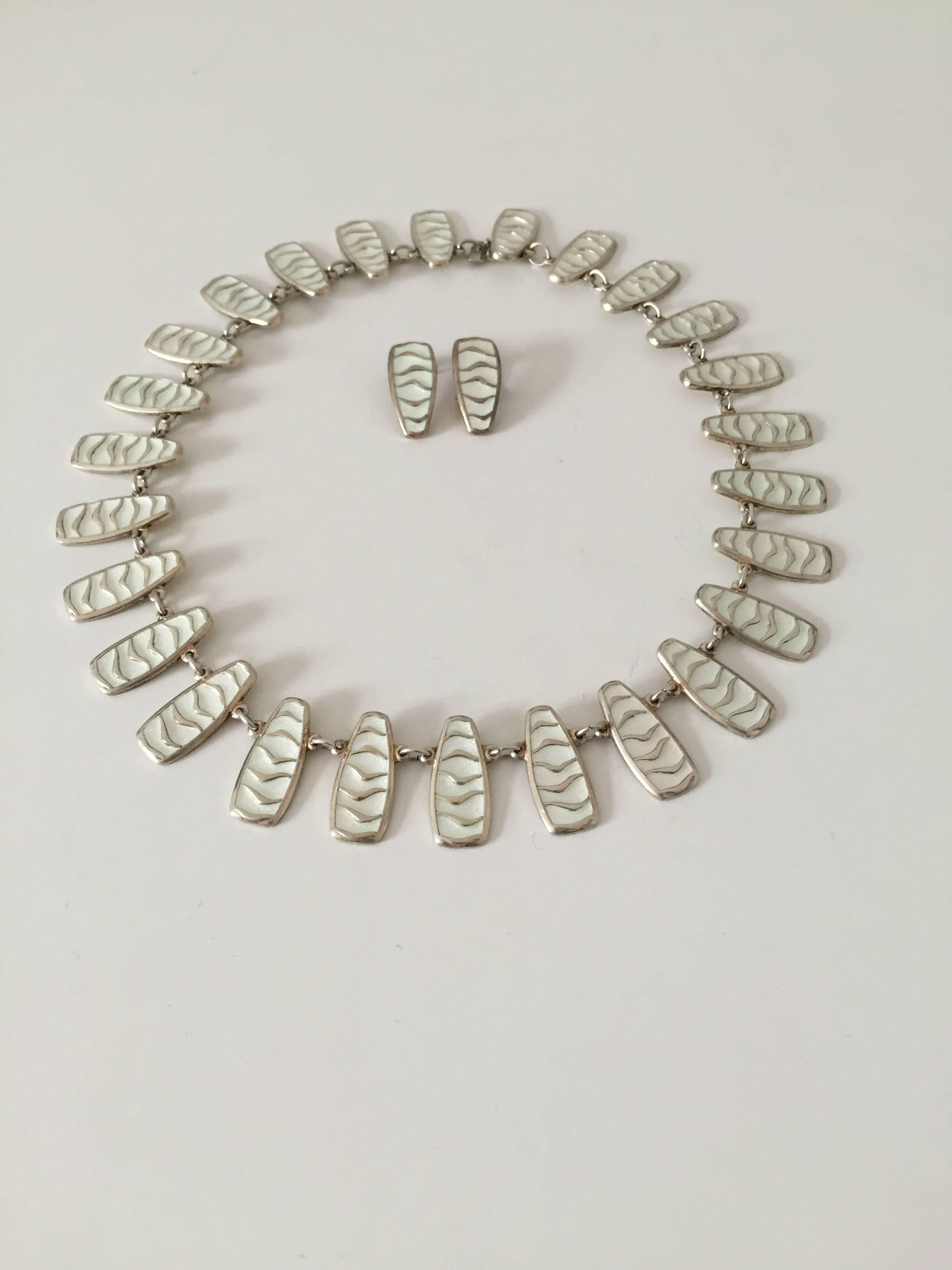 David Andersen sterling silver with enamel necklace and earclips. Is in good condition. 

David Andersen is a Danish jewelry company established in 1876 producing its own jewelry line as well as selling jewelry by brands like Georg Jensen and Ole