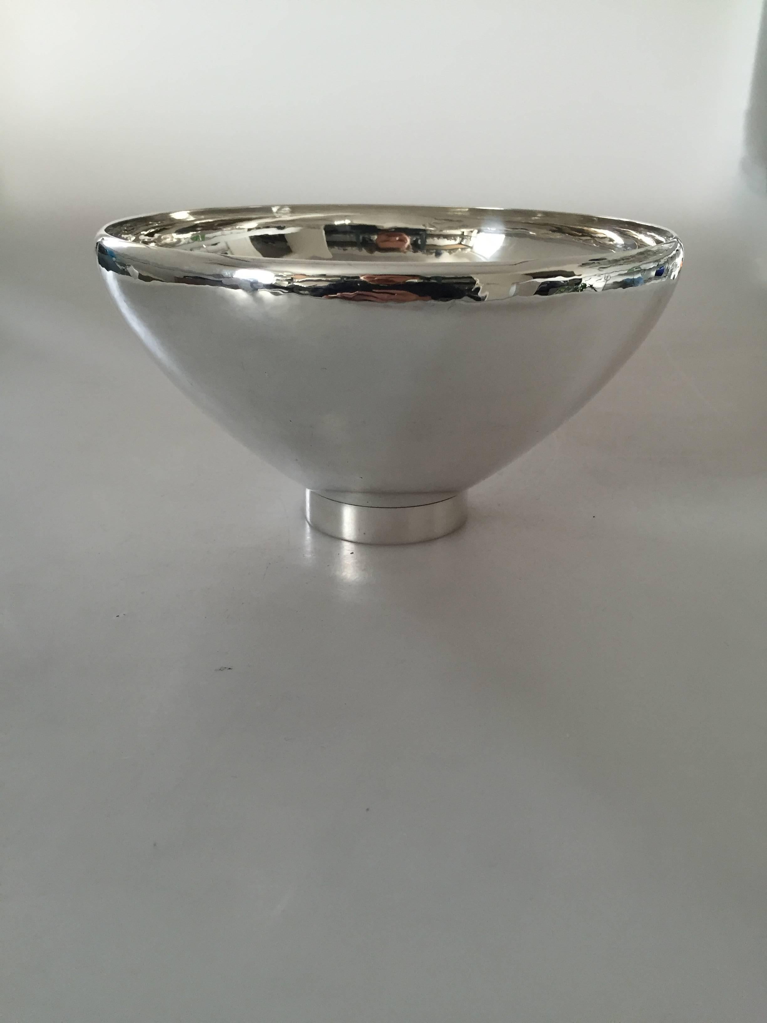 Georg Jensen sterling silver bowl #484B. 

Measures 10.5 cm tall x 19 cm diameter.

Georg Jensen (1866-1935) opened his small silver atelier in Copenhagen, Denmark in 1904. By 1935 the year of his death, he had received world acclaim and was