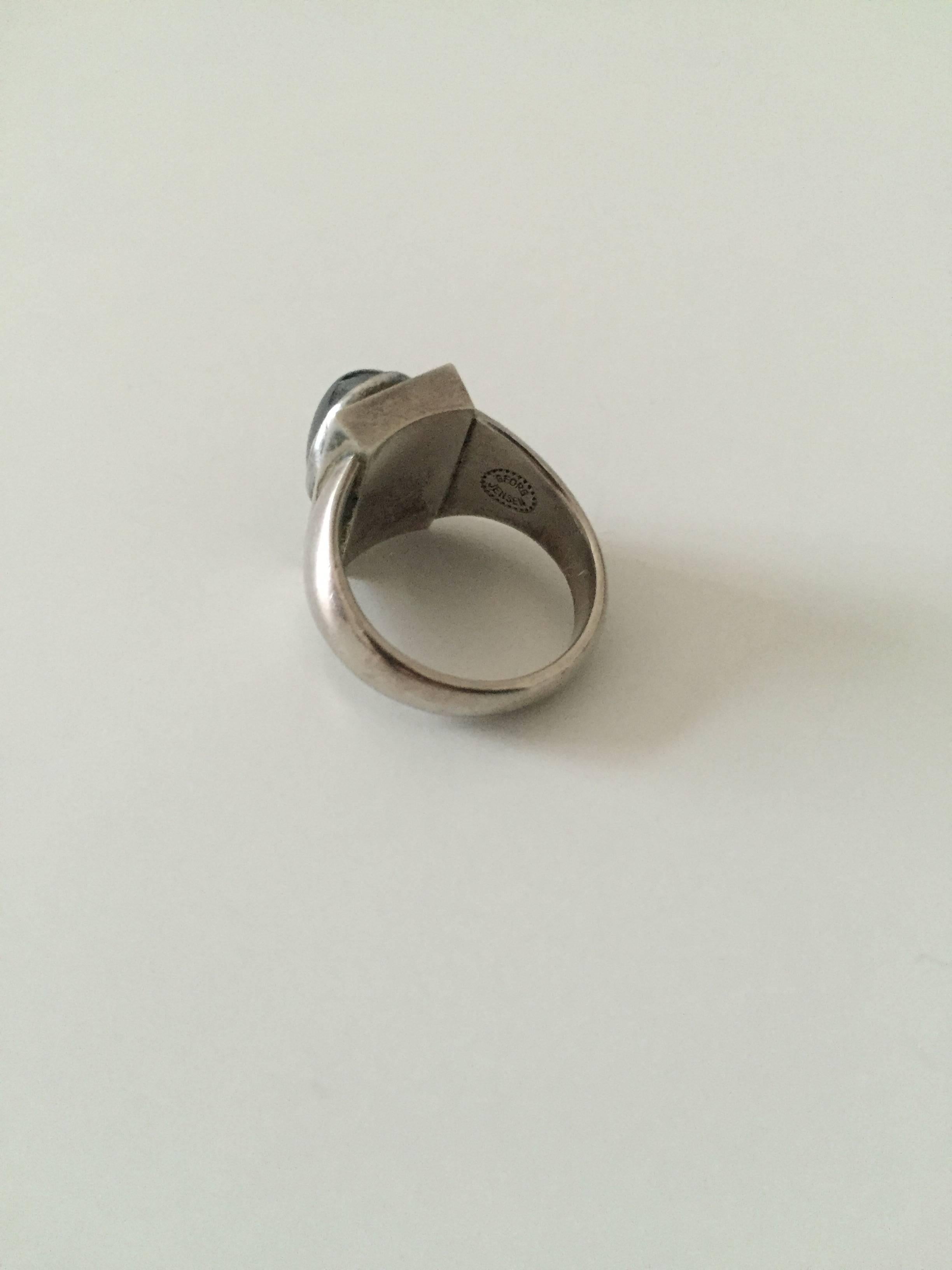 Georg Jensen sterling silver ring with stone #84. 

Size 50. 
Weighs 8.6 g / 0.30 oz

Georg Jensen (1866-1935) opened his small silver atelier in Copenhagen, Denmark in 1904. By 1935 the year of his death, he had received world acclaim and was