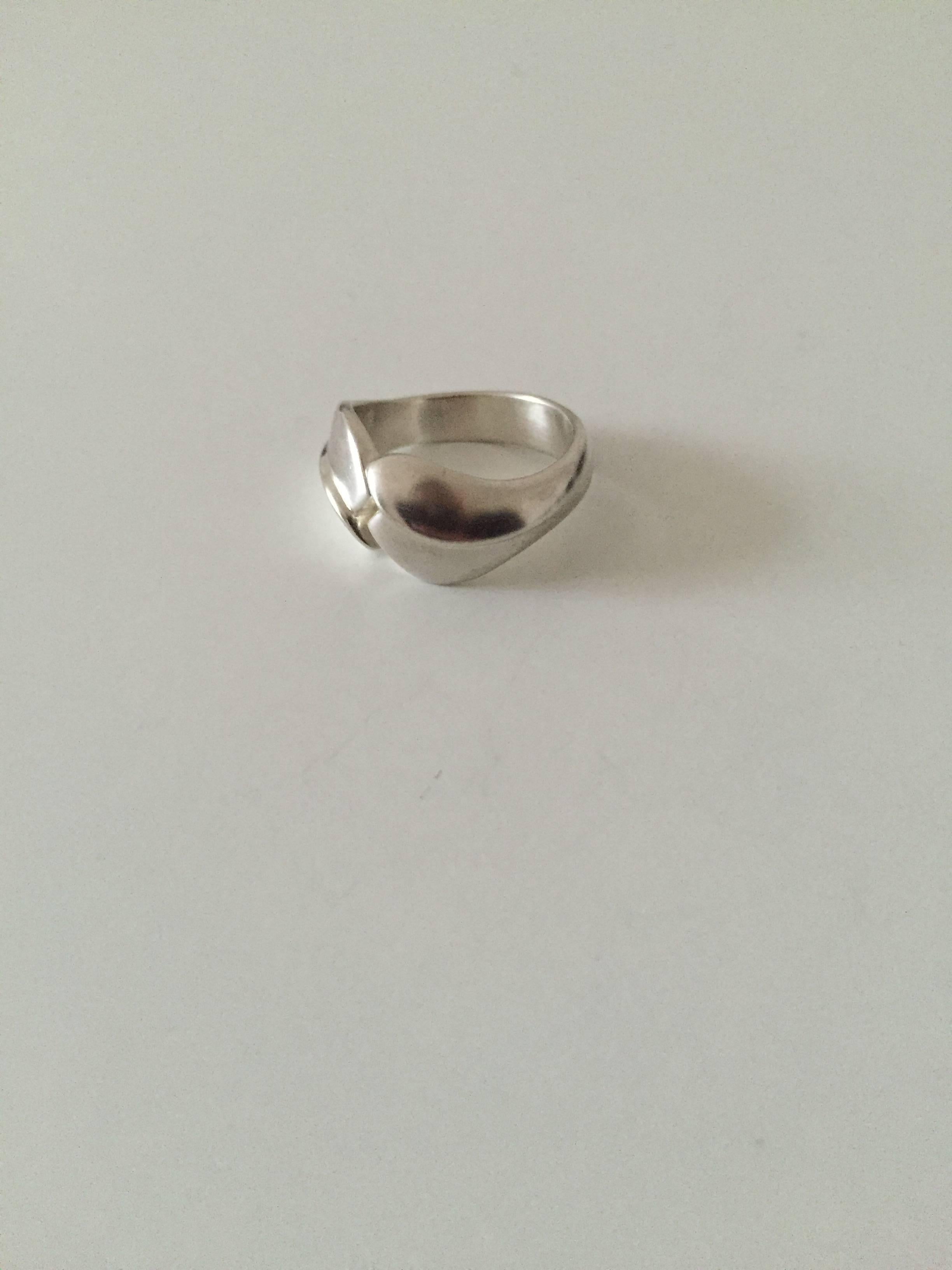 Georg Jensen sterling silver modern ring.

Ring size 52. 
Weighs 6.5 g / 0.23 oz

Georg Jensen (1866-1935) opened his small silver atelier in Copenhagen, Denmark in 1904. By 1935 the year of his death, he had received world acclaim and was