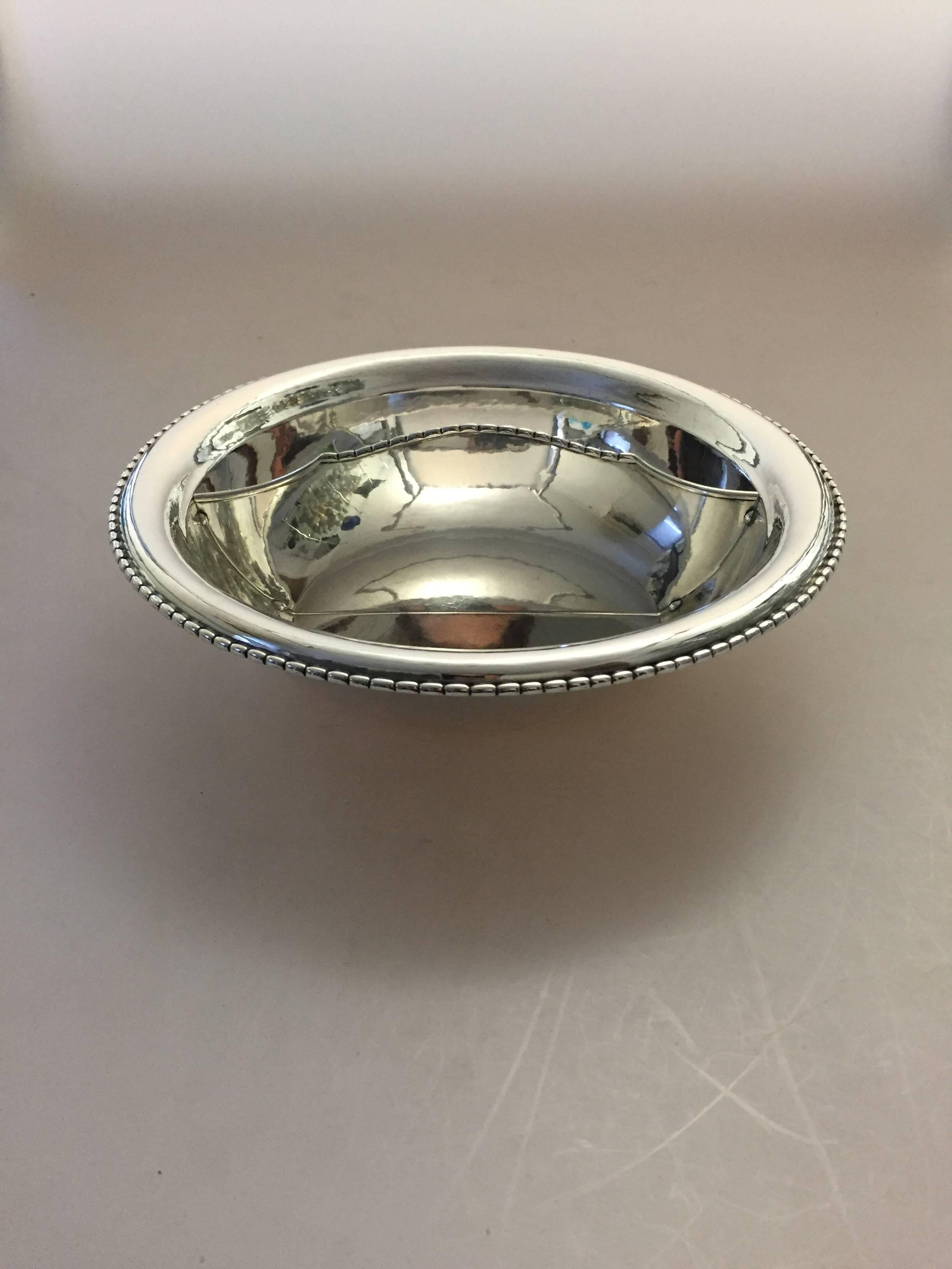 Georg Jensen sterling silver bowl with divider #290L.

Measures 25.5 cm dia.