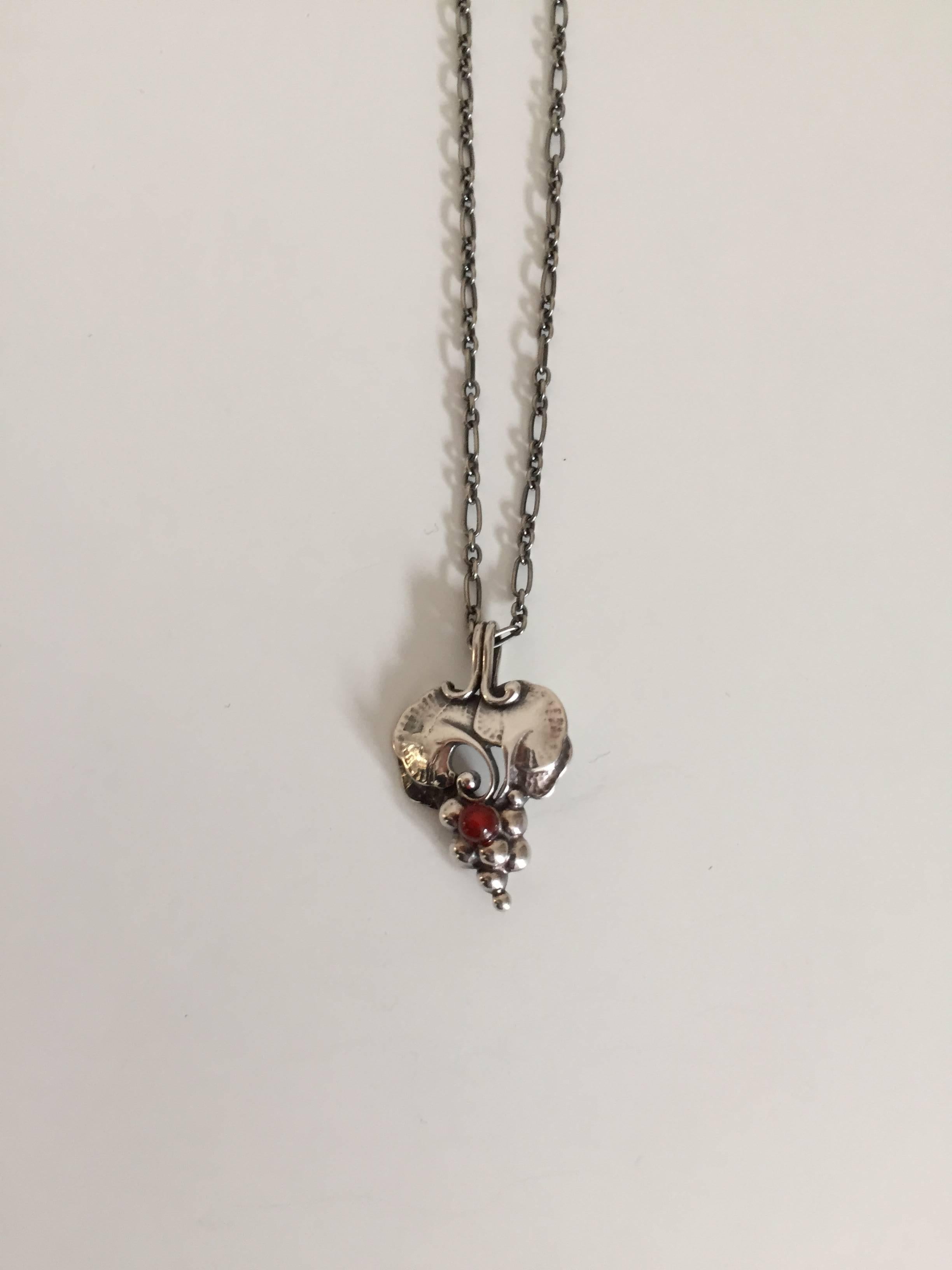 Georg Jensen sterling silver annual pendant with red stone from 1996. 

Chain measures 44.5 cm L. 
Weighs 11 g / 0.35 oz.