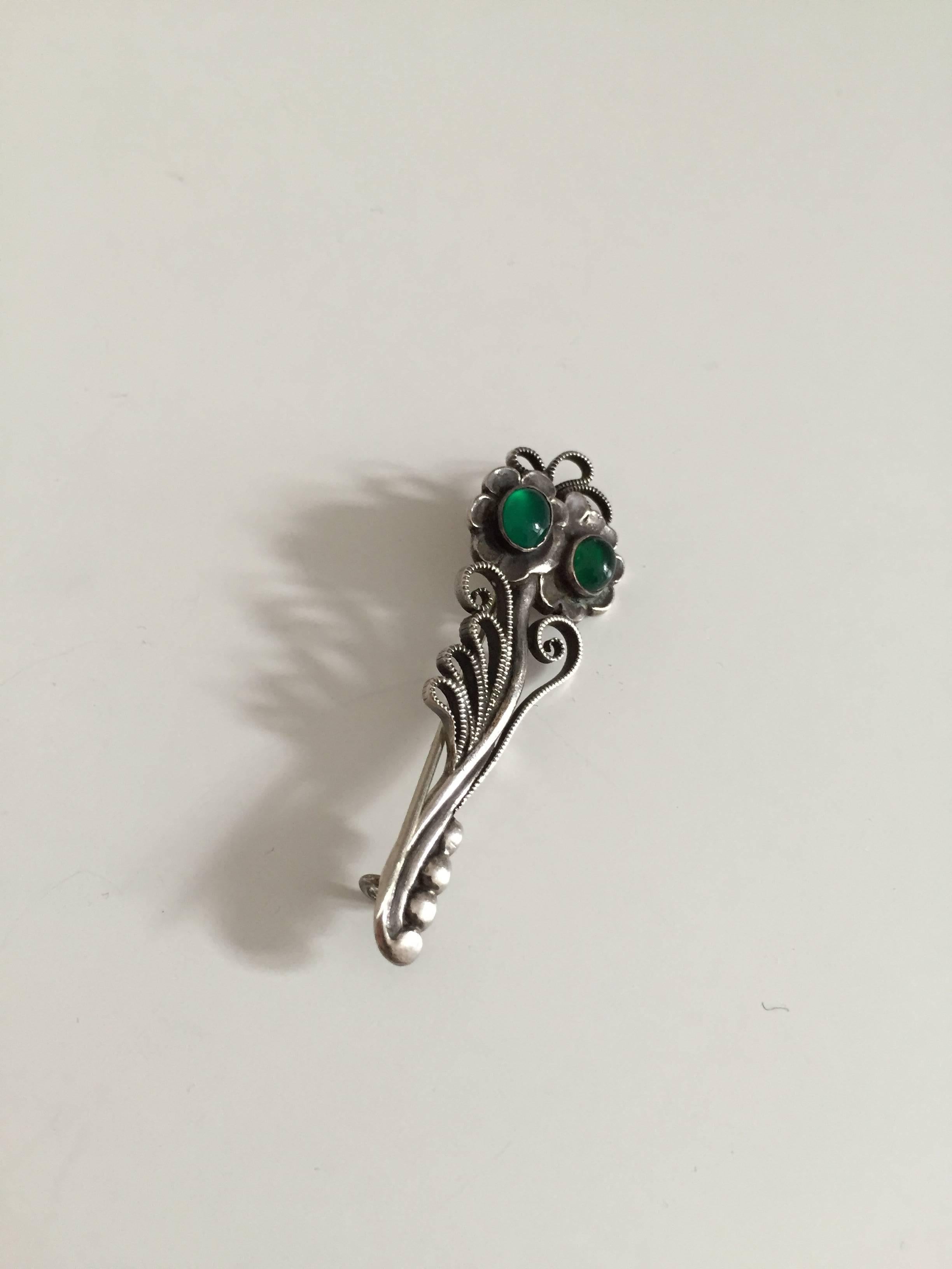 Georg Jensen sterling silver brooch with green agat #182 from 1910-1920. Is in good used condition.

Measures 5.3 cm (2 3/32