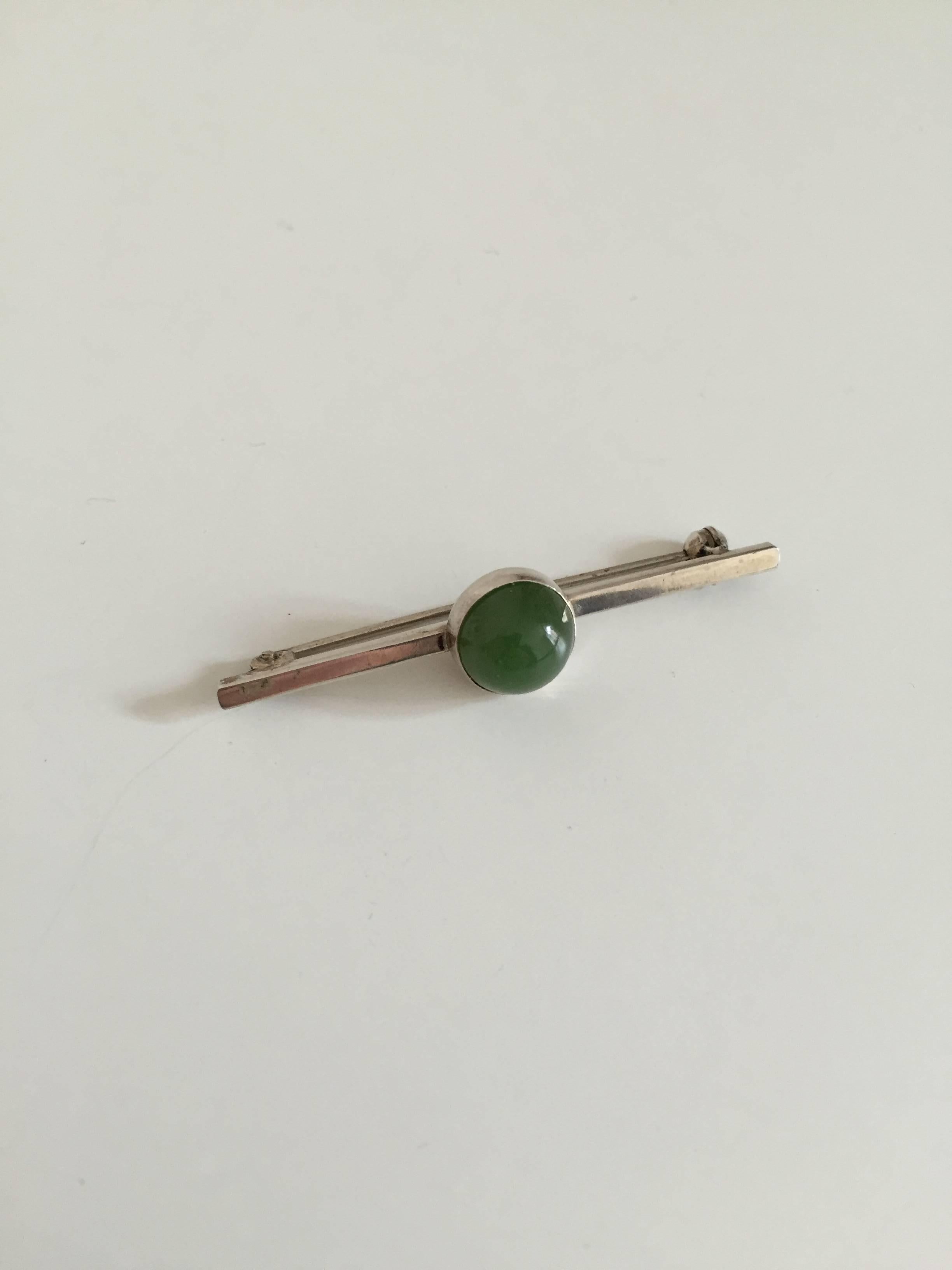 Georg Jensen sterling silver brooch with green agate. 

Measures: 5.3 cm. Weighs 5 g / 0.18 oz.

 