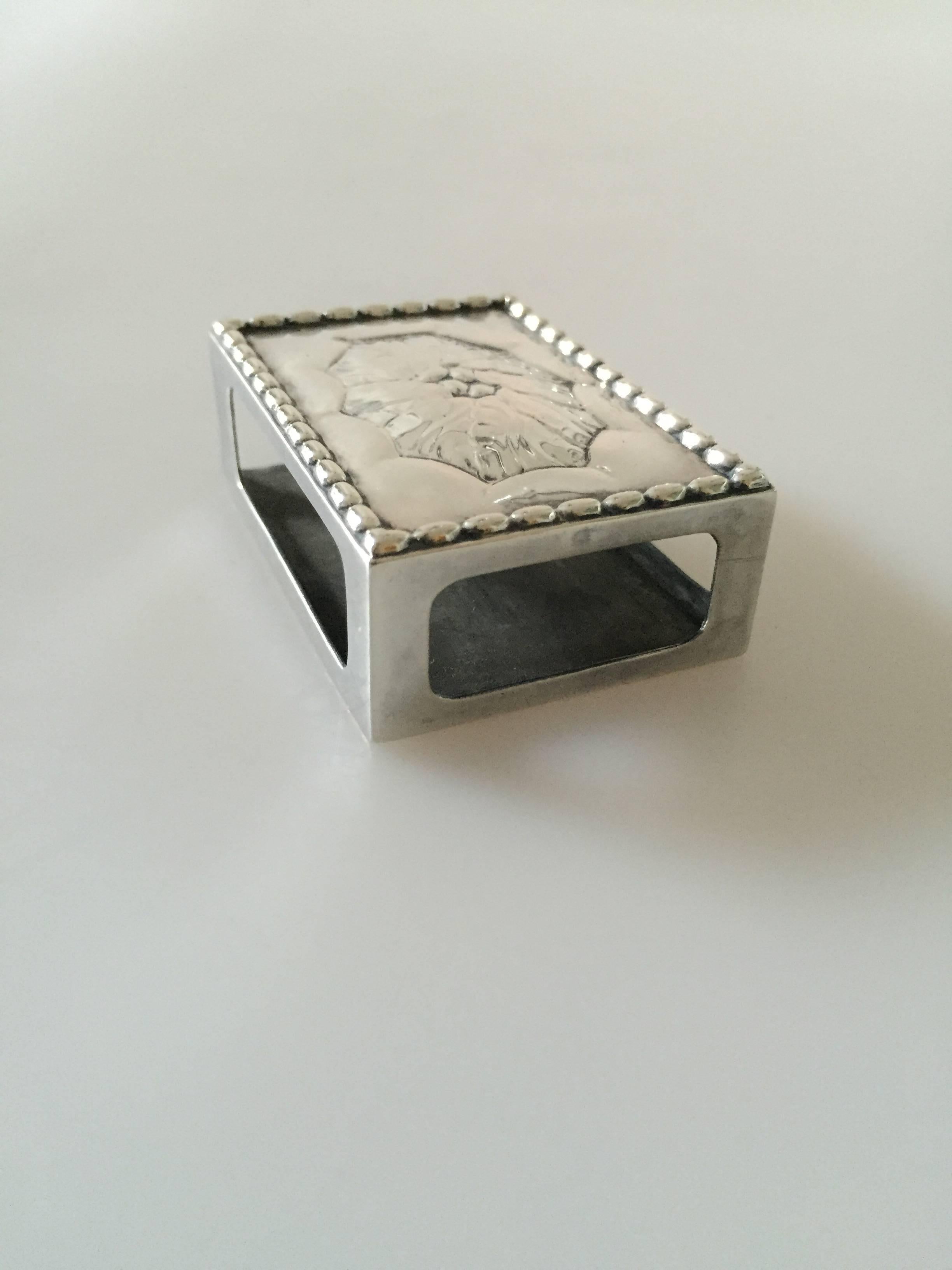 Georg Jensen sterling silver matchbox holder #83C. With old marks.

Measures 5.5 cm x 3.9 cm x 2 cm.