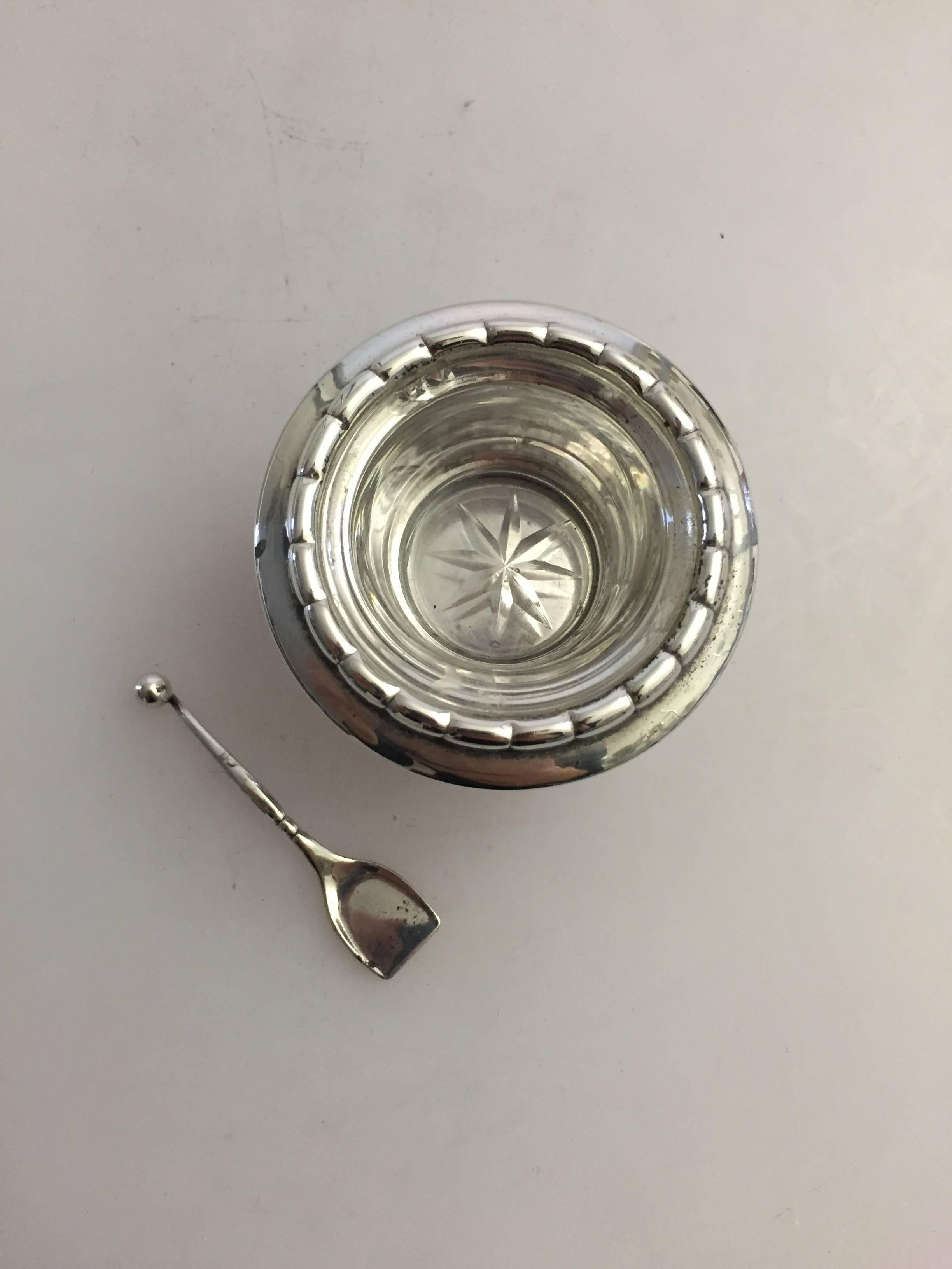 Georg Jensen sterling silver salt dish #236 and spoon #130. The salt dish comes with an original inserted glass cup. The glass have a few chips here and there but the dish can bed used with or without the glass. Made with marks from