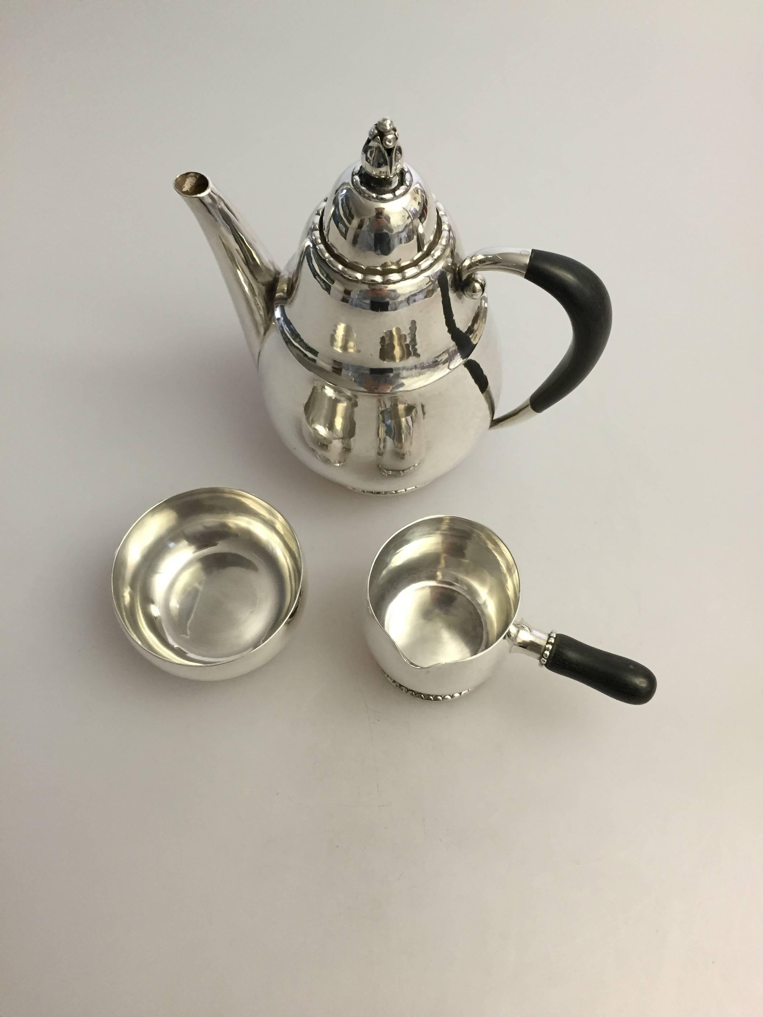 Georg Jensen sterling silver mocca coffee set #34, with pot, creamer and sugarbowl, from 1925-1933.

 Combined weight is 610 g / 21.40 oz.
 Measurements: Pot 17.5 cm H, 12 cm in diameter, creamer 7 cm H, 6 cm in diameter, sugarbowl 5 cm H, 7.3 cm