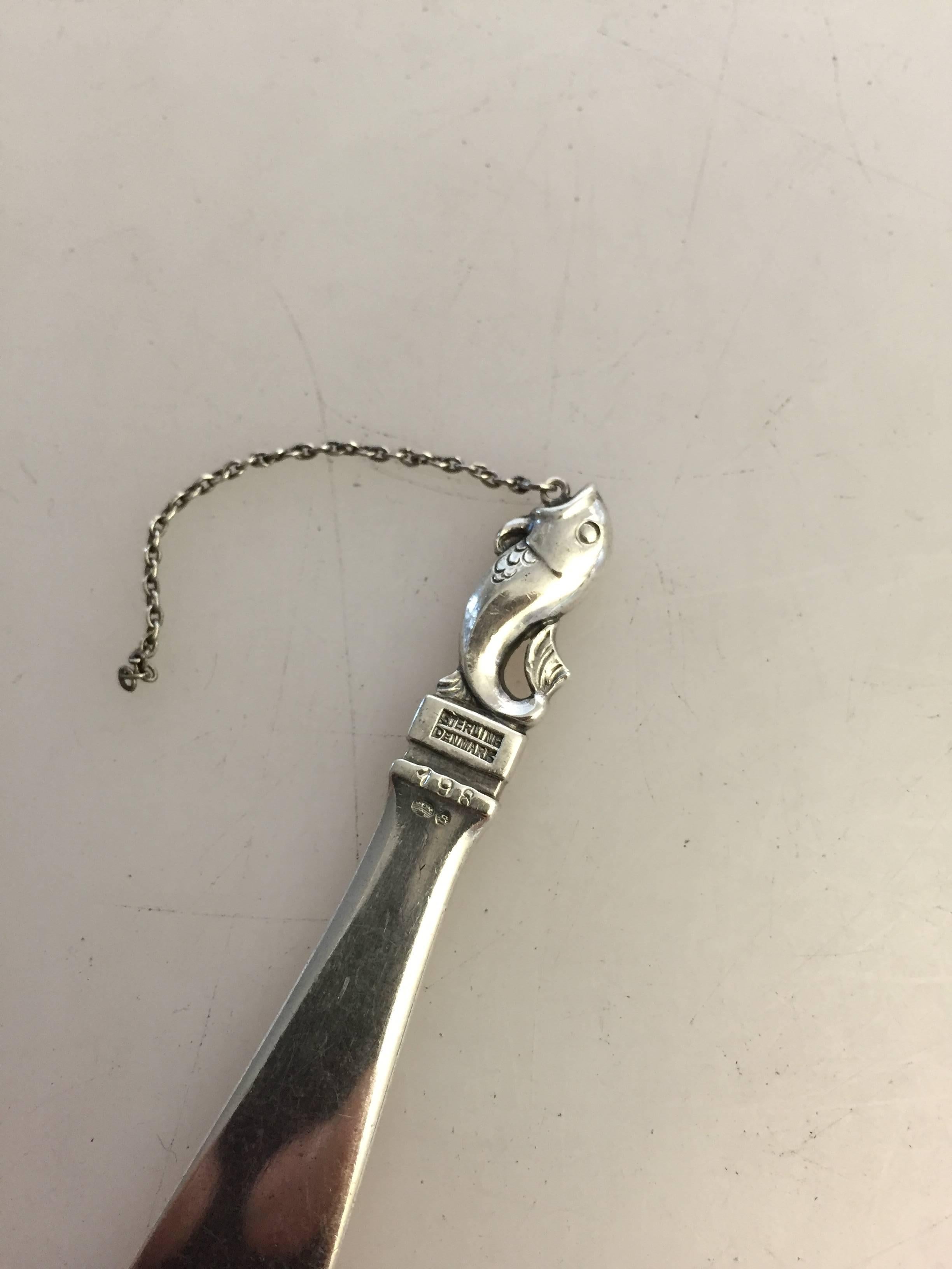 Georg Jensen sterling silver letter opener #198 with fish ornament. From 1933-1944.

Measures: 11.7 cm L.
Weighs 21 g / 0.80 oz.