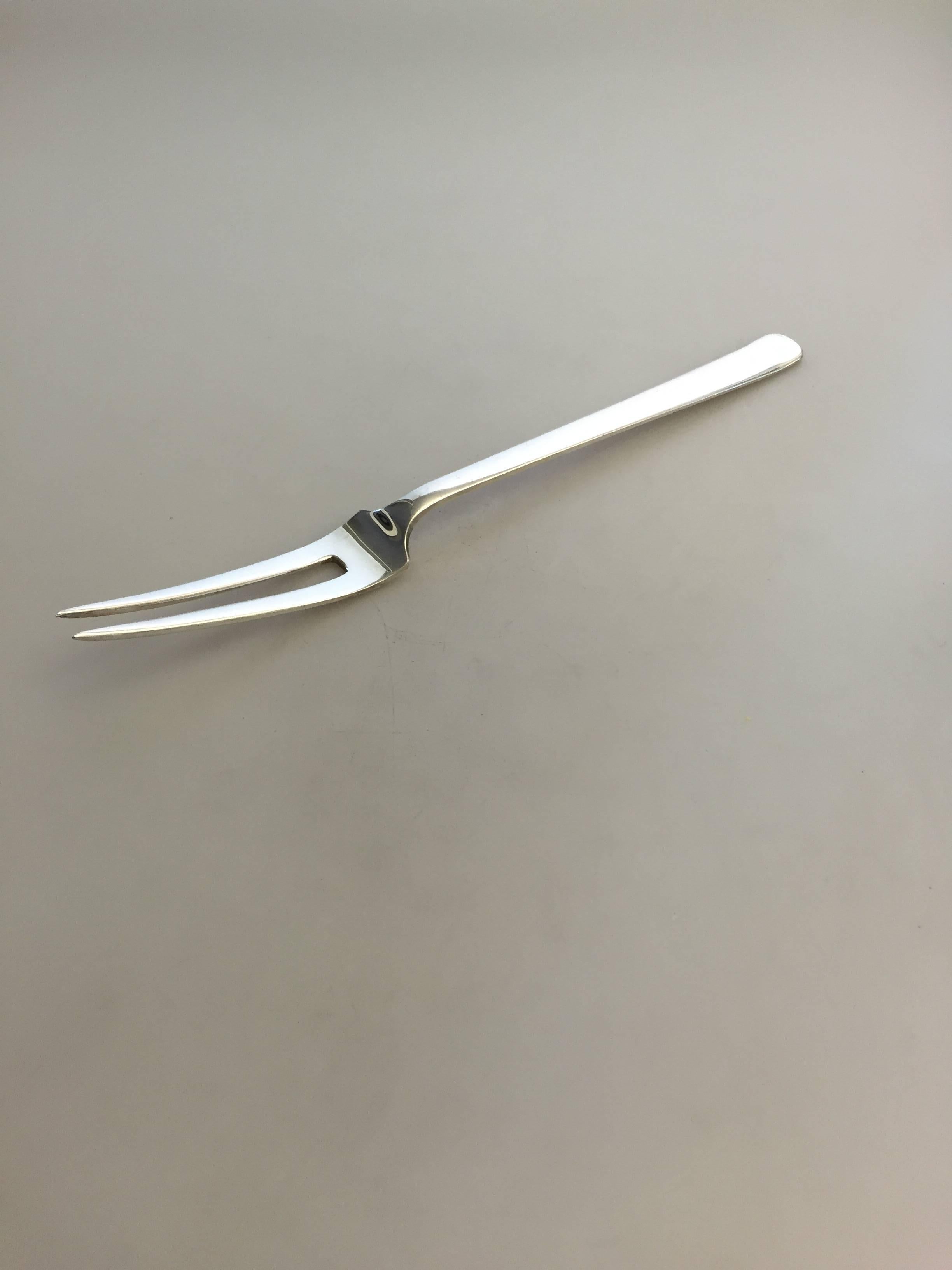 Kay Bojesen large meat serving fork in silver. From 1930.

Measures: 27.3.
Weighs 3.85 oz / 110 g.

Kay Bojesen (1886– 1958) was a Danish silversmith and designer. He is best known for creating wooden animels, especially his wooden monkey which