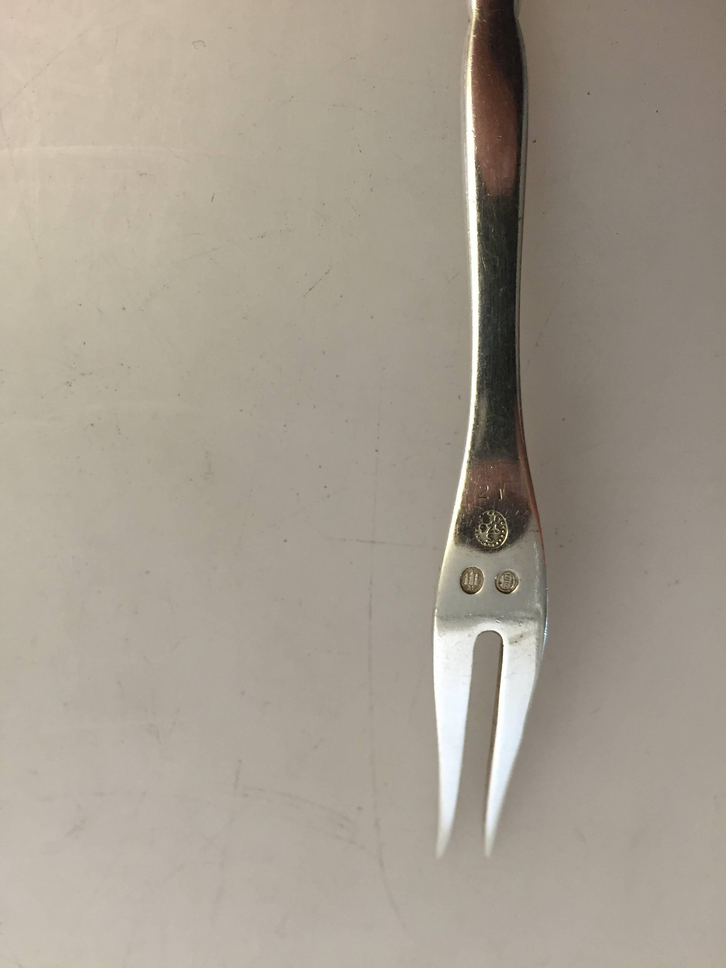 Georg Jensen sterling silver cocktail fork #21. 

Measures 14 cm.
Weighs 19 g / 0.70 oz.
   