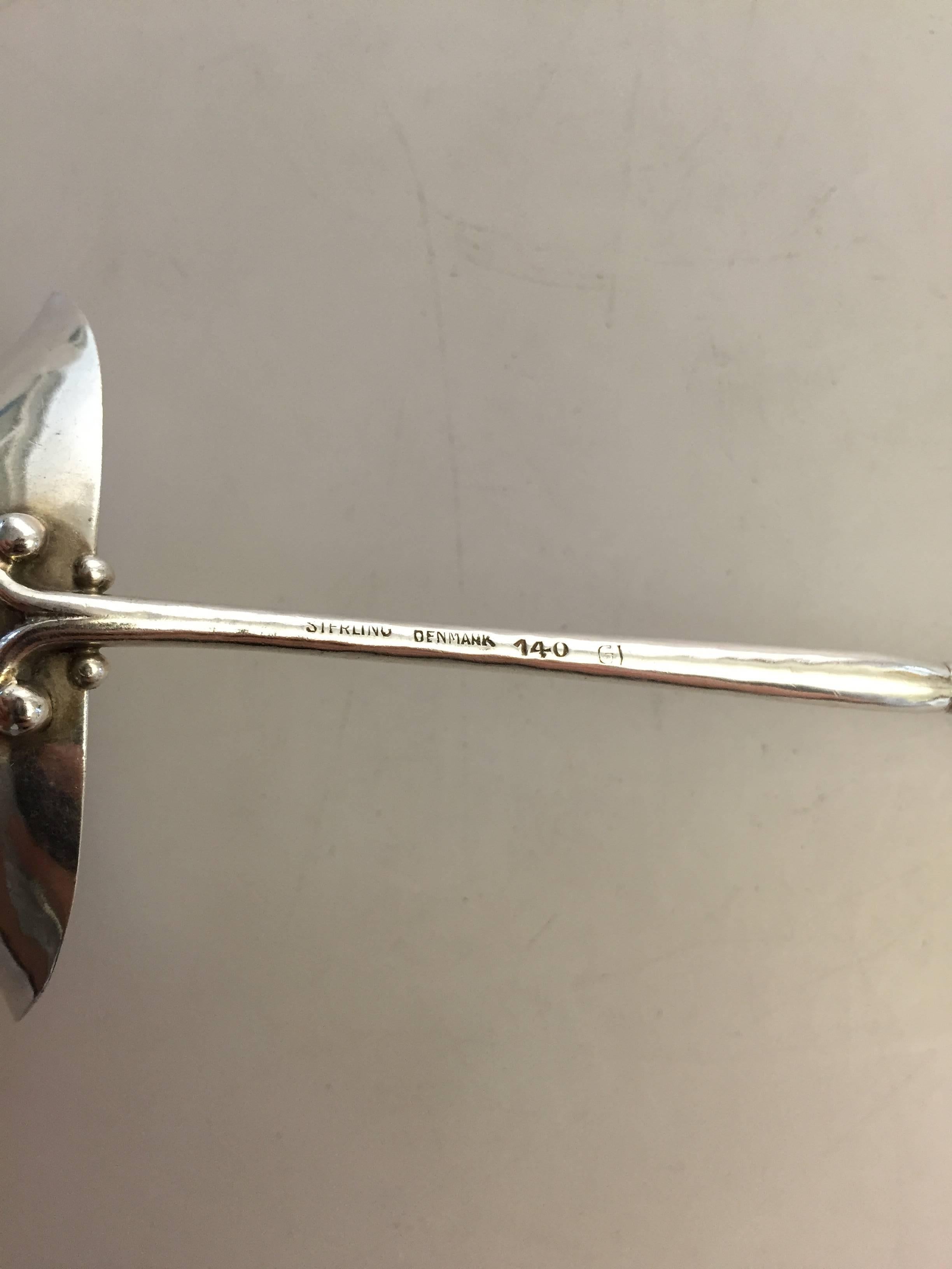 Early Georg Jensen sterling silver ornamental gravy spoon #140, from 1909-1914.

Measures: 14 cm.
Weighs 32 g / 1.15 oz.