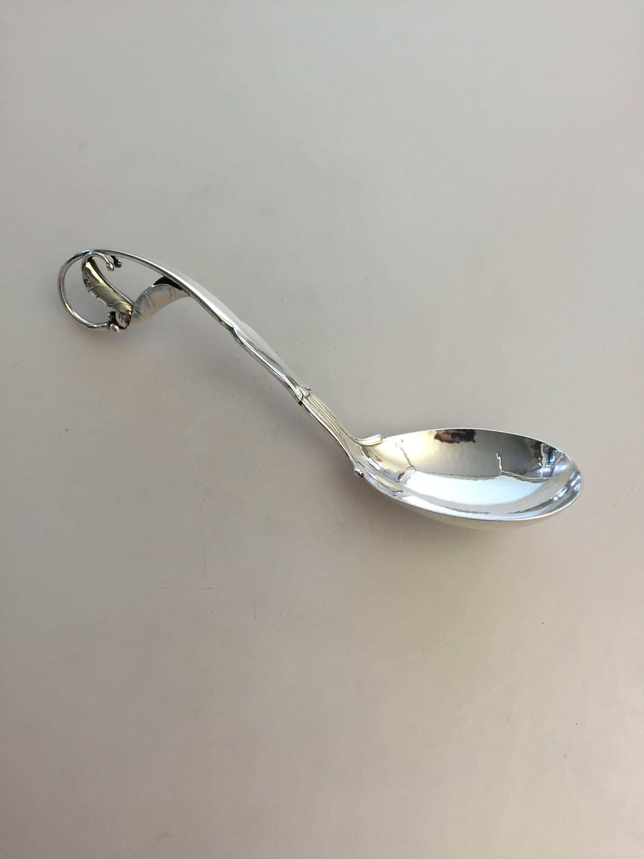 Georg Jensen sterling silver ornamental spoon from #141. The spoon is from 1931. 

Measures: 20.6 cm L.
Weighs 78 g / 2.75 oz.