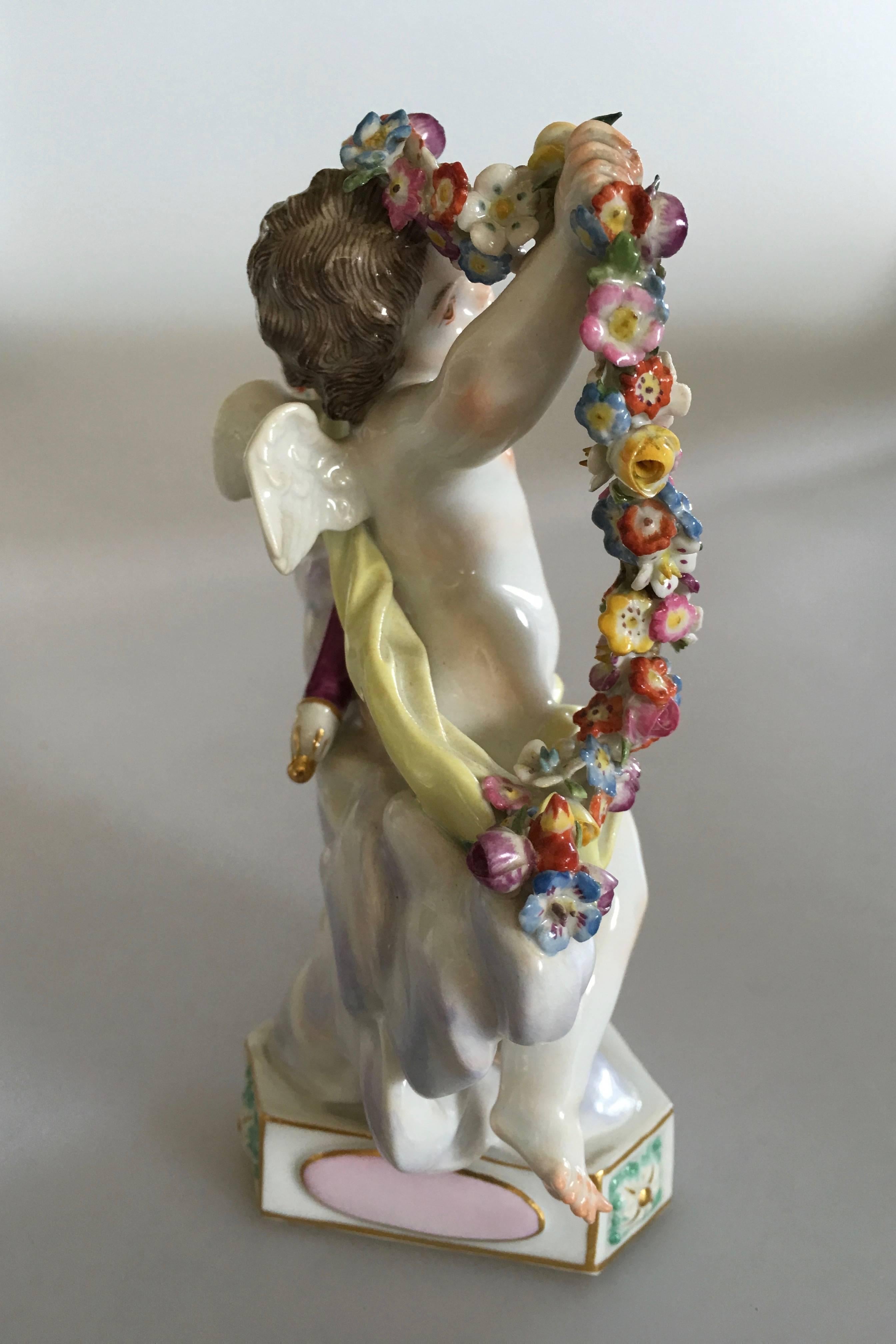 Meissen Figurine of Winged Putti holding a Floral Wine. Likely from after 1934. In perfect condition with no chips. 