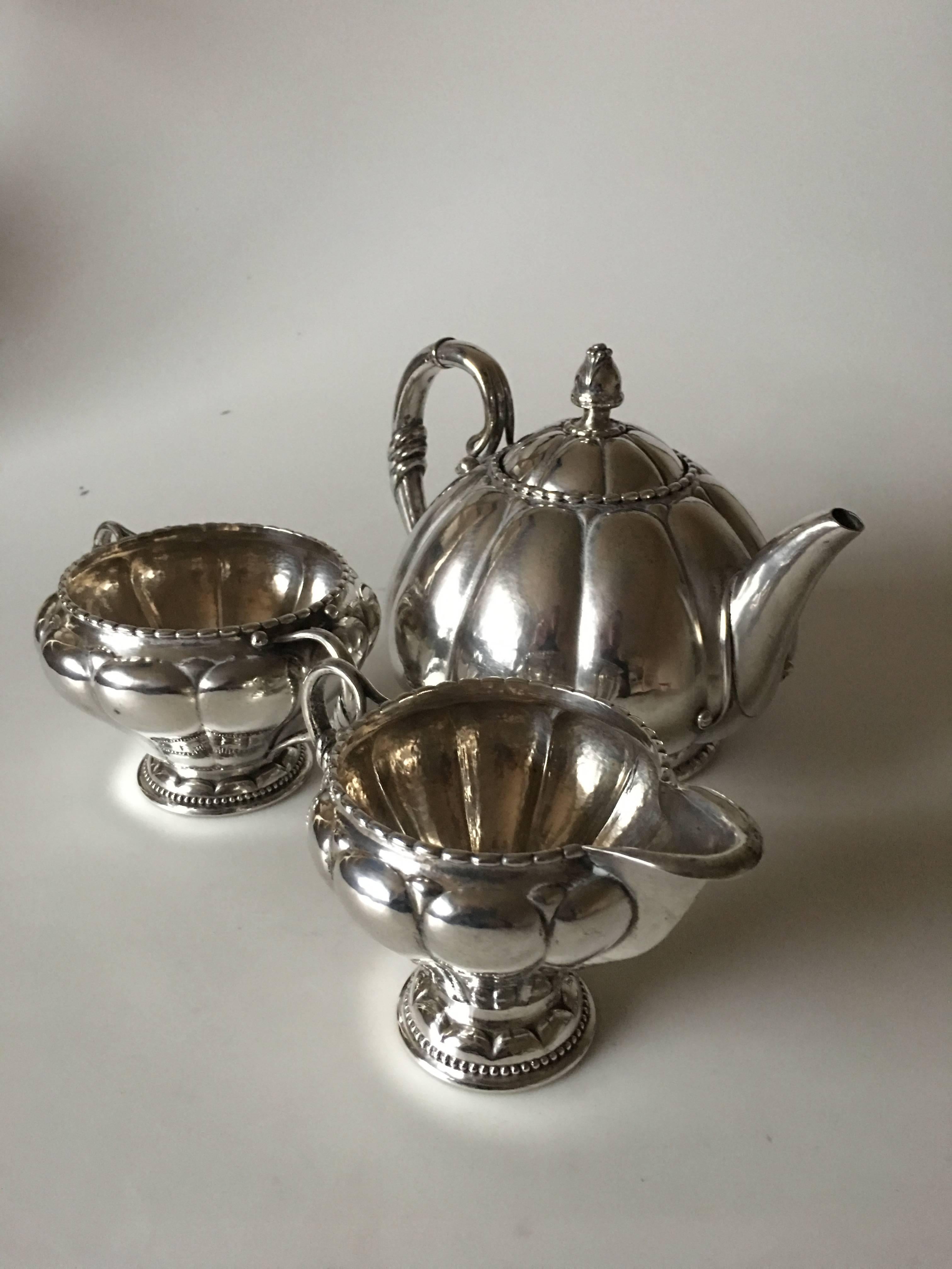 Georg Jensen tea set #26 in silver with early marks. From 1904-1908. Teapot one weighs 532 grams. 14 cm H (5 33/64