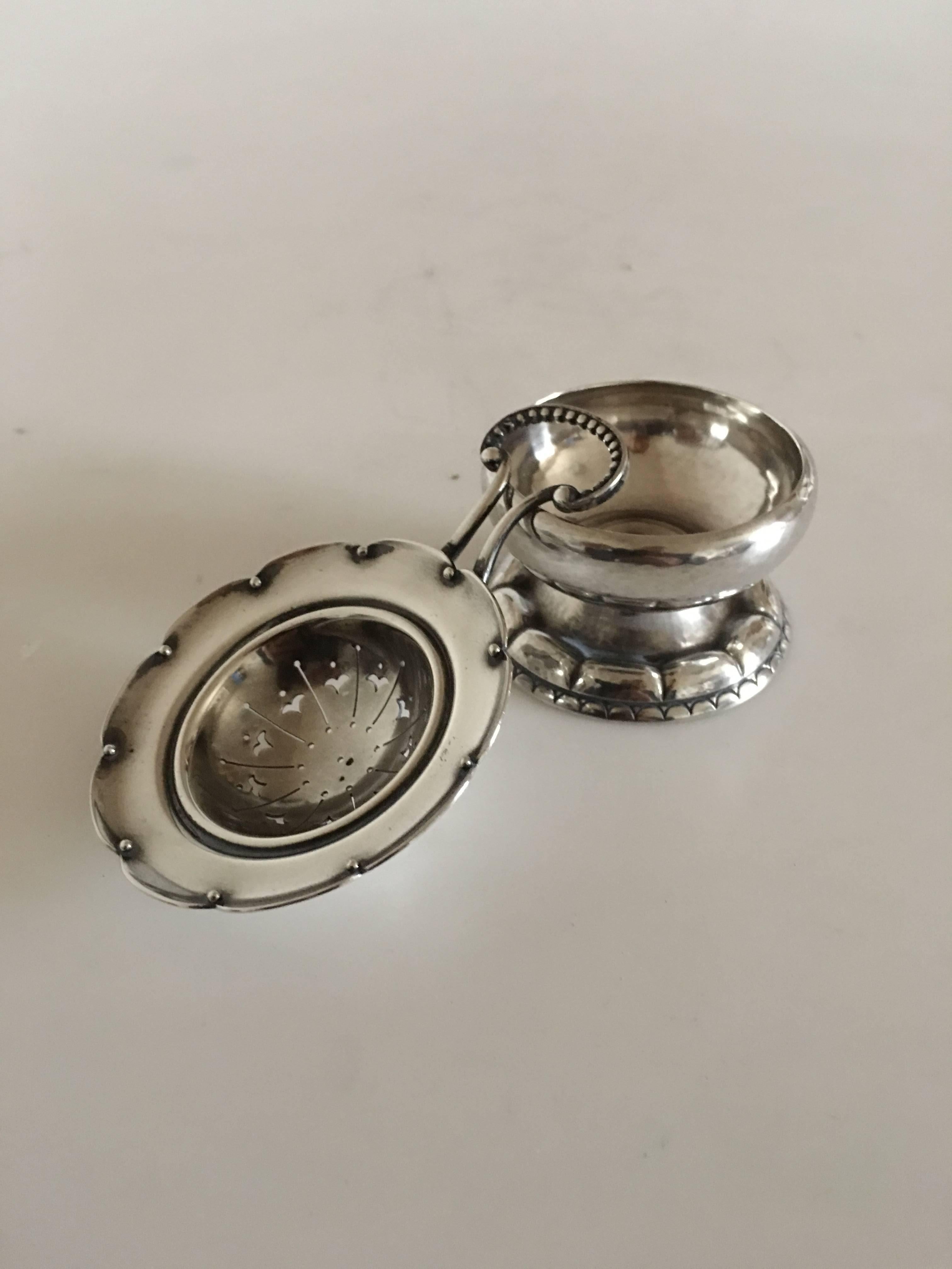 Georg Jensen sterling silver tea strainer and tea strainer holder #34. Measures: 4 cm H (1 37/64