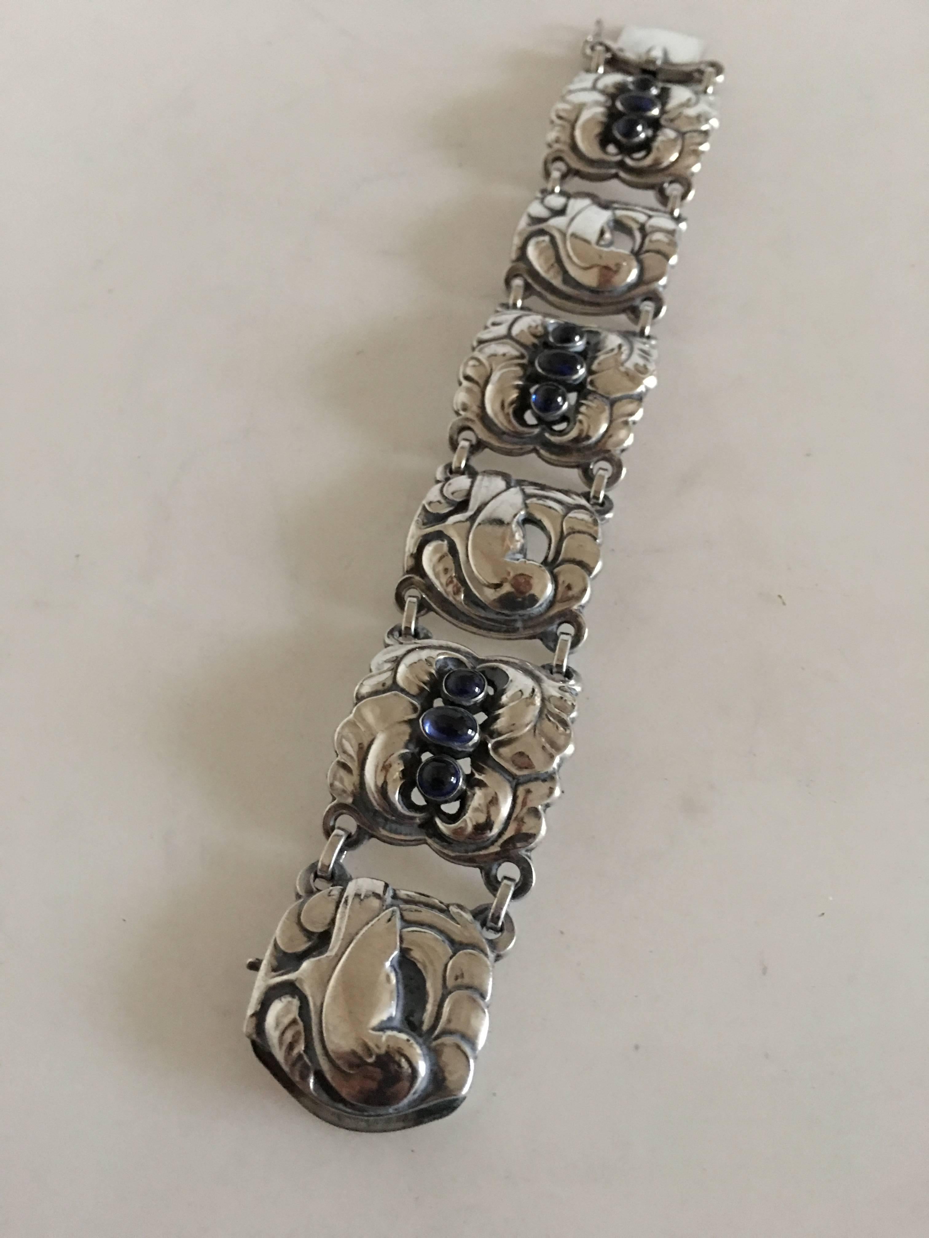 Georg Jensen sterling silver bracelet #32 with synthetic sapphire. Measures: 19 cm L (7 31/64). Weighs 54 grams. From after 1945.
