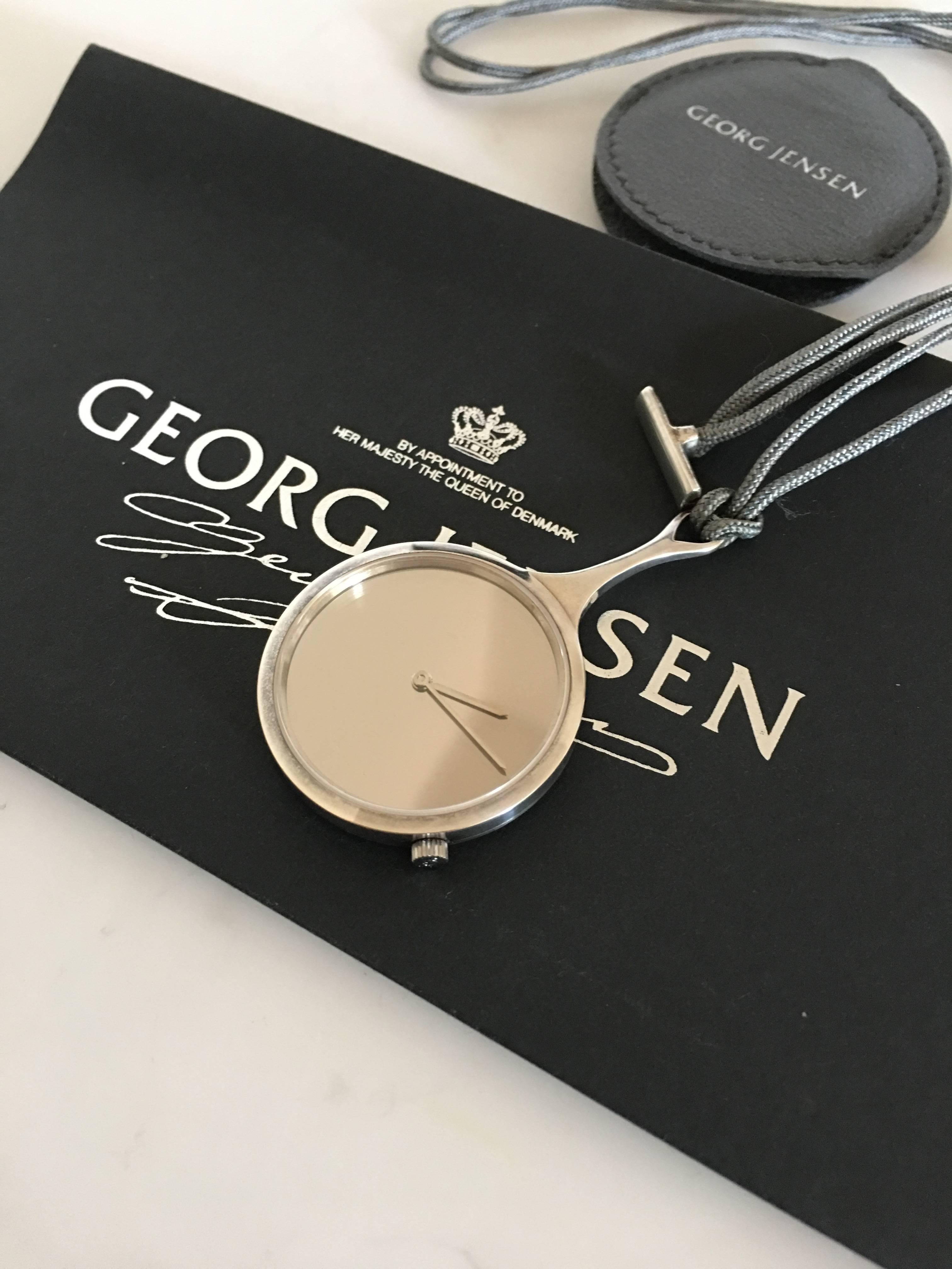 Georg Jensen Swiss made water resistant sterling silver watch pendant no. 2325 designed by Vivianna Torun Bülow-Hübe. Created as a pendant with chain to carry around the neck. 

The watch has a diameter of 3.3 cm (1 19/64