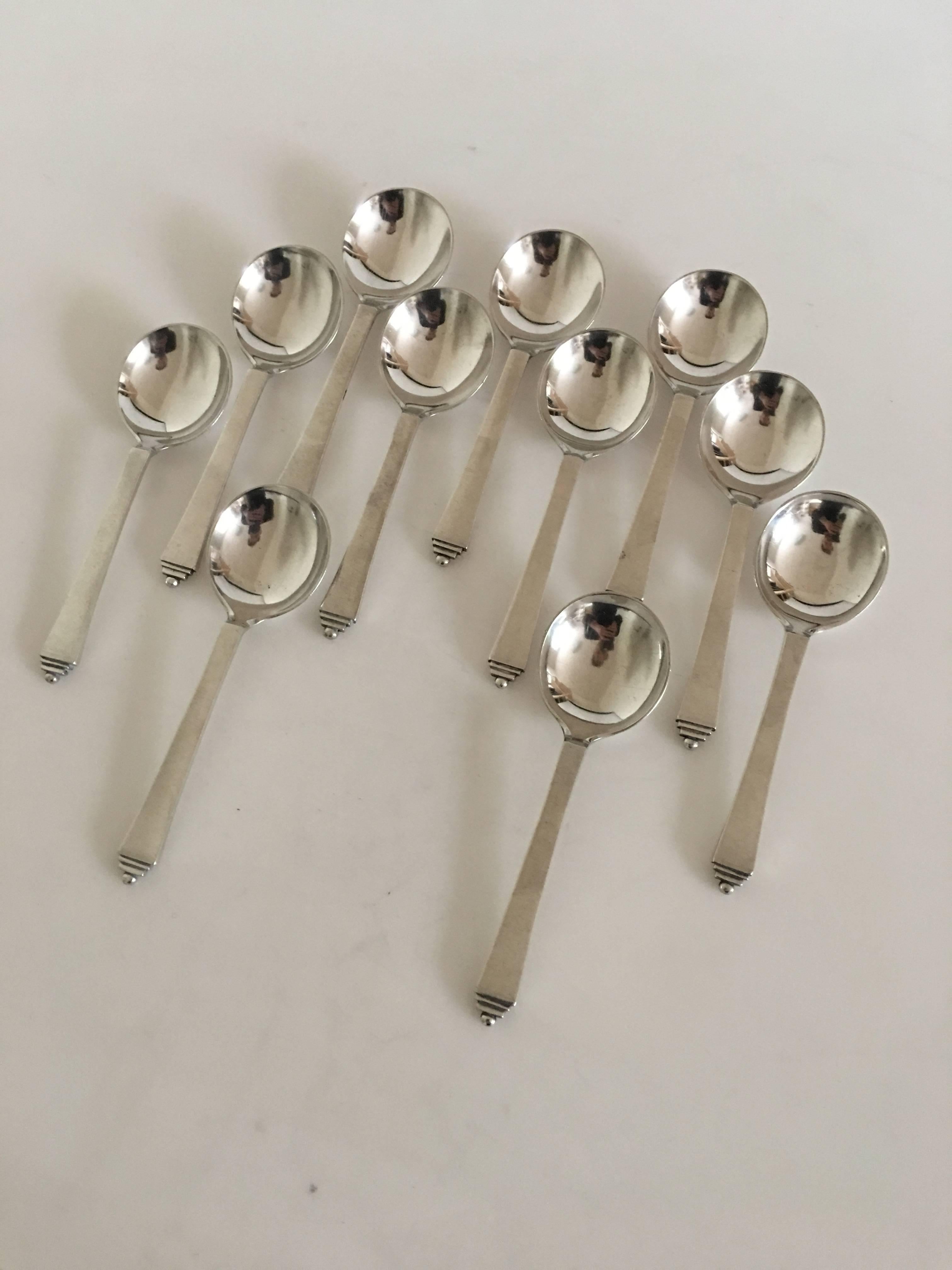 Georg Jensen sterling silver Pyramid set of 11 Bouillon spoons with early GJ silver hallmarks from 1920s. Measures 13 cm L (5 1/8