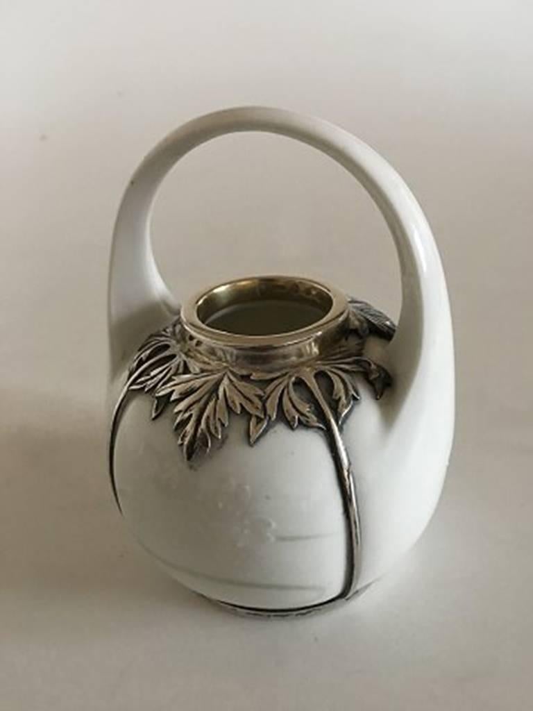 Royal Copenhagen Art Nouveau vase with Anton Michelsen sterling silver mounting from 1911. Nice rare pink glaze, with flowers in relief. In perfect condition.