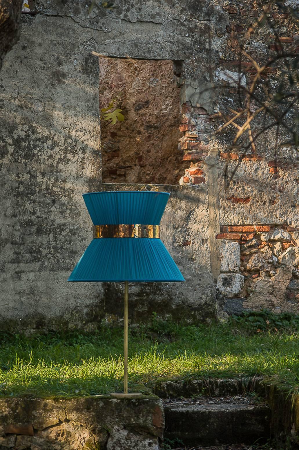  This Table lamp is a contemporary piece, entirely made in Tuscany and manufactured in an artisanal way. 
The structure consists of a brass tube and its base both with antique finish. The lampshade is made of soft pleated bright silk organdy,