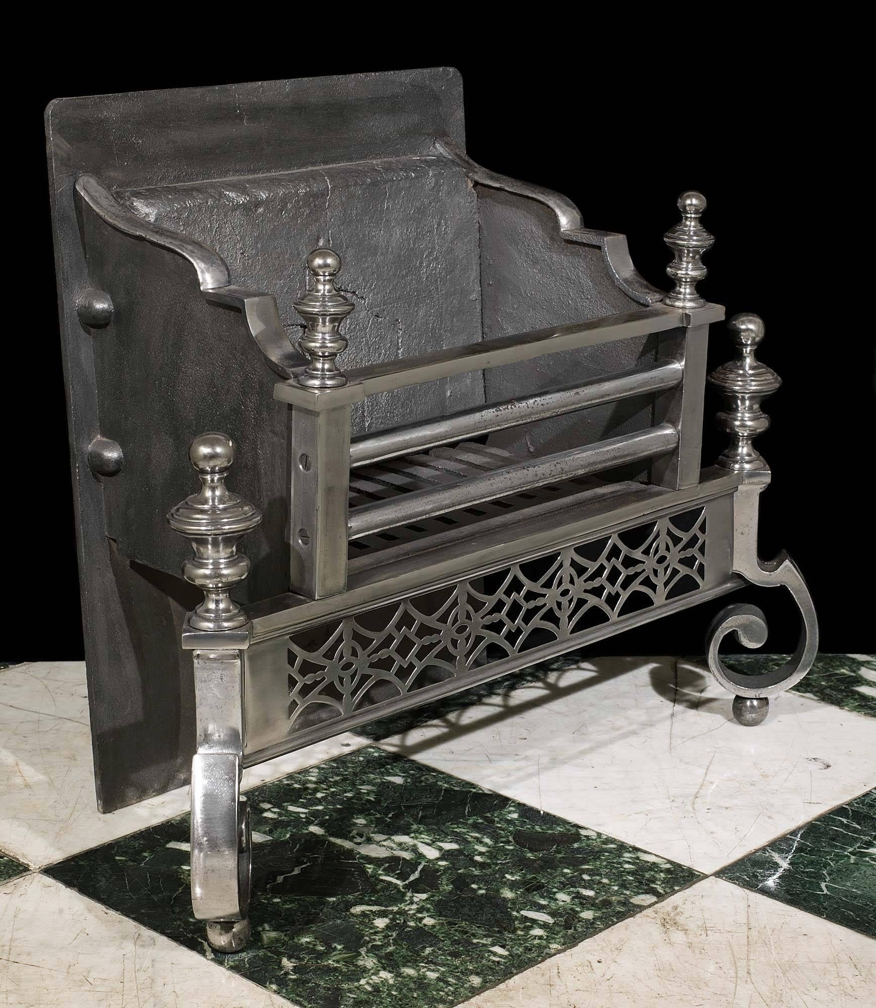 A smart polished steel three barred Georgian style antique fire basket with four mounted knopped finials, a diamond design pierced apron and supported on a pair of robust scrolled legs,

English, late 19th century. 

(Prices + vat in EU zone).