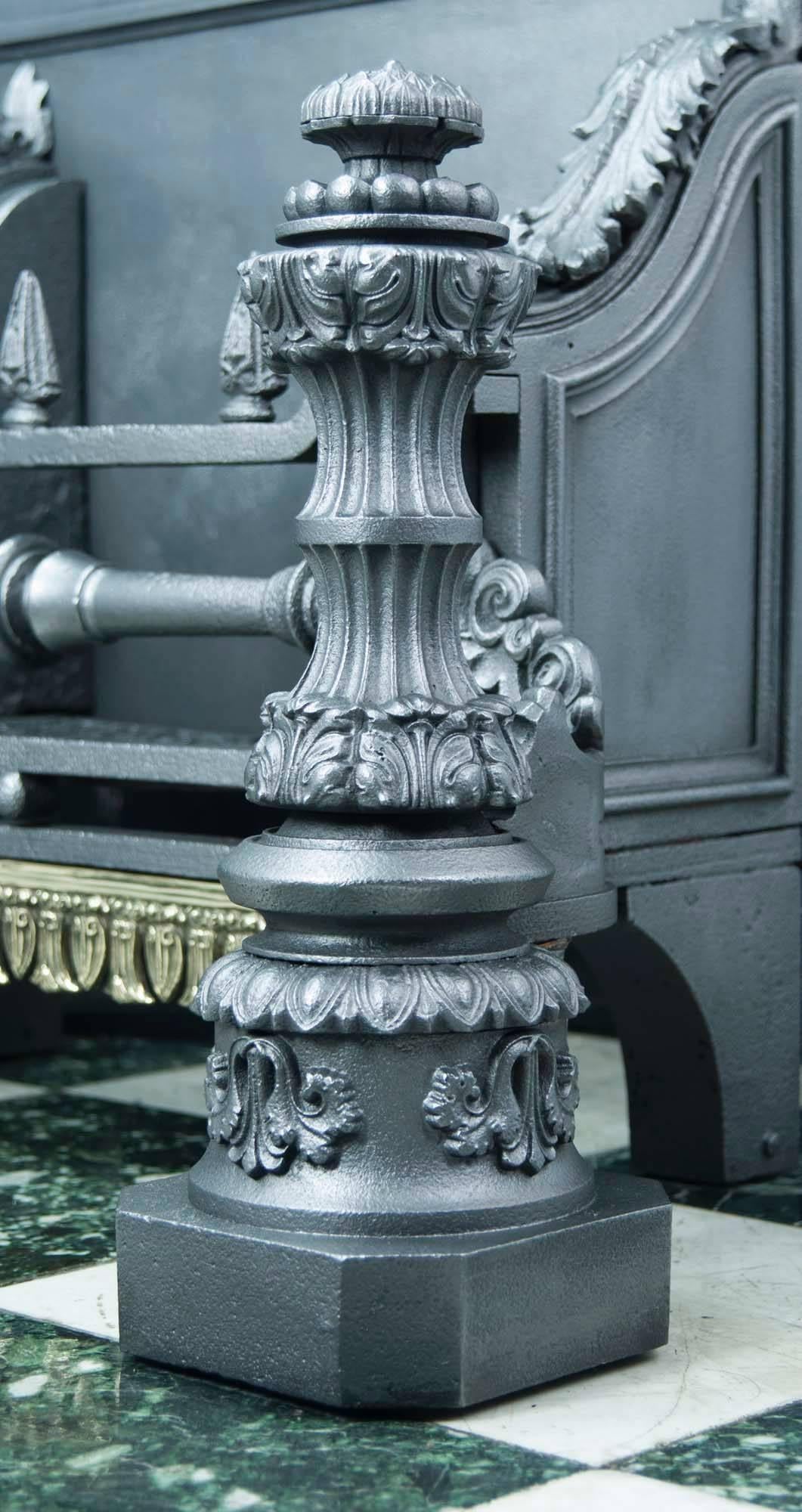 A very large and rare heavy cast iron Baroque style fire basket with Greek influences, the square backplate topped with scrolled anthemion motifs, acanthus decoration on the shoulders of the wide and deep grate. The pair of large baluster style