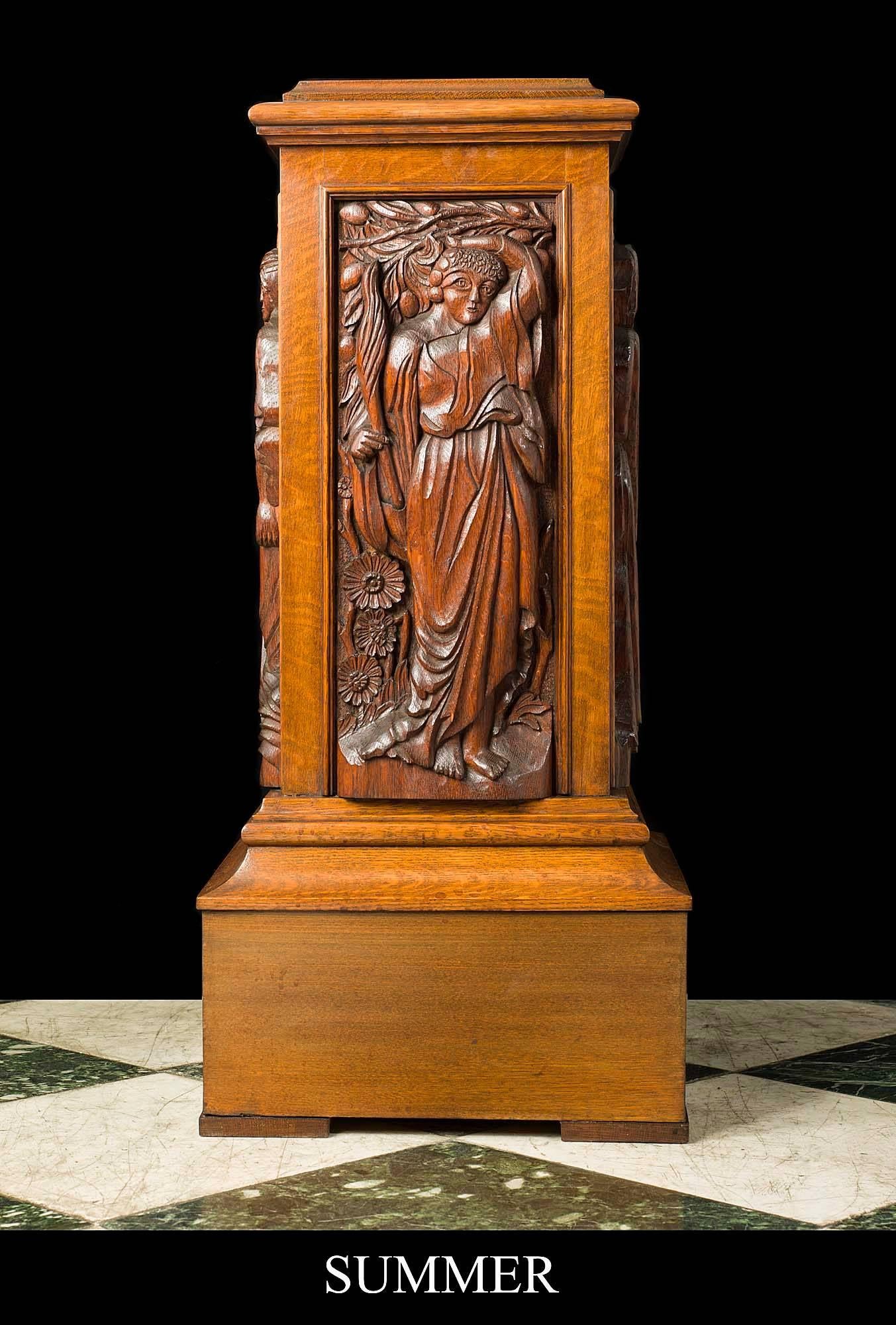 A very decorative and unusual Arts & Crafts antique oak pedestal. The moulded square top is set above four carved panelled sides raised on a moulded plinth base. Each panel has a figure carved in high relief representing the four seasons of Spring,