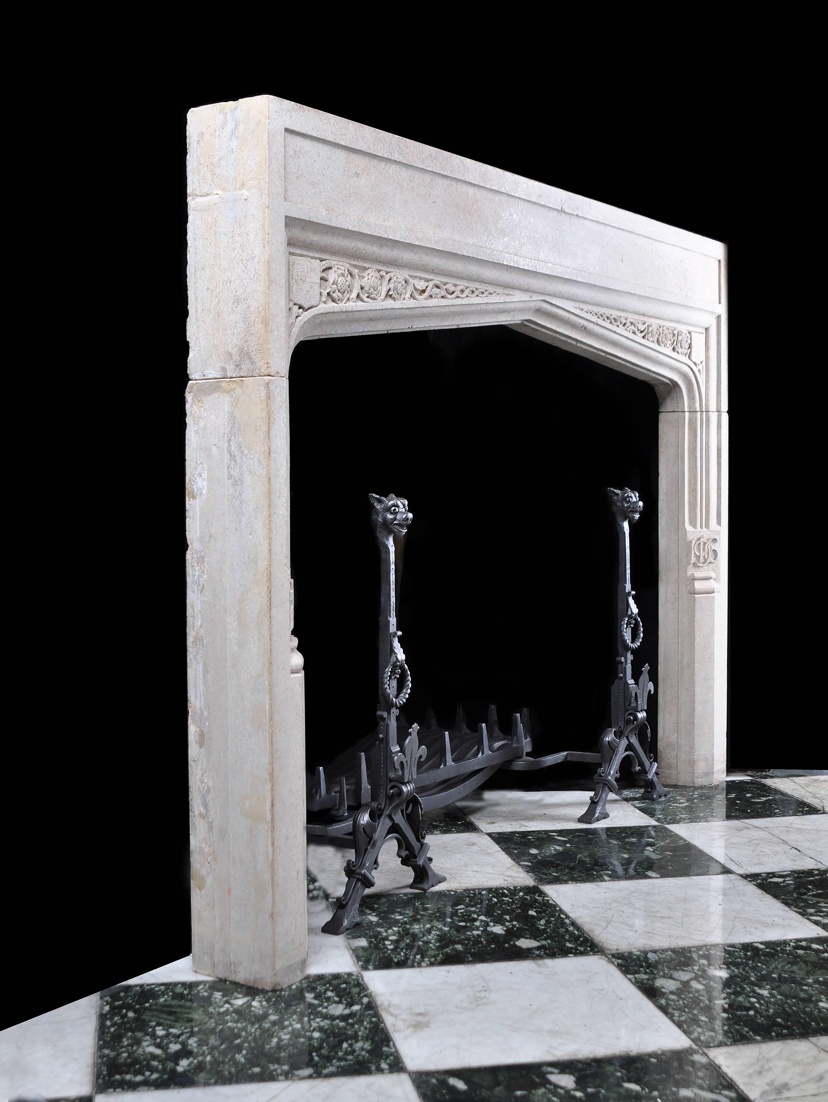 A substantial Tudor Revival style Derbyshire Fossil Limestone chimneypiece. The spandrels are carved with trailing rosette and shield motifs, the left jamb carved with the initials FPVC, the right jamb carved with the date 1916.