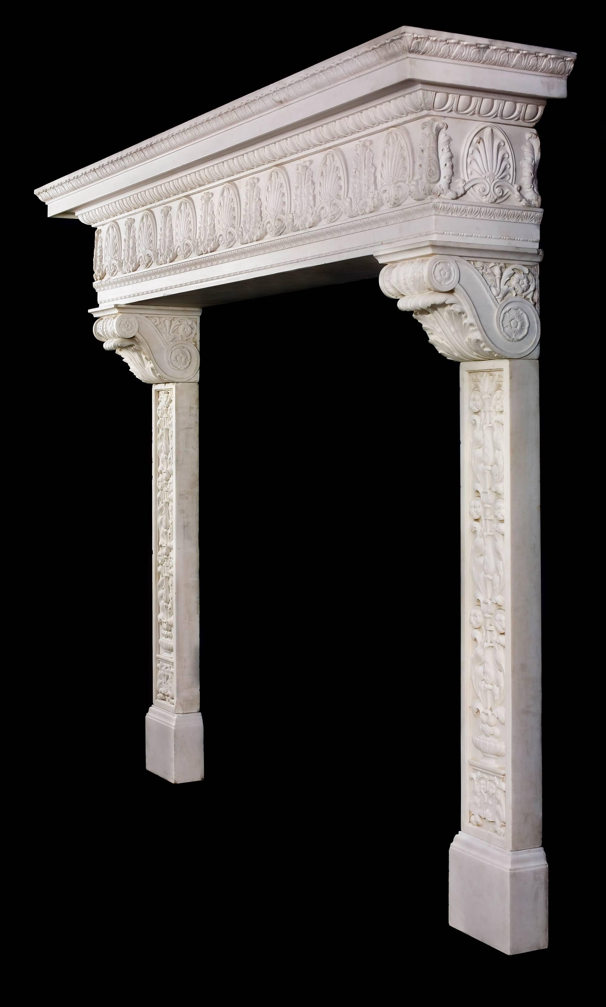 A grand Italian Renaissance style antique fireplace mantel in white Statuary marble. The stepped shelf, edged with richly carved lambs tongue detail over an egg and dart border, sits above a very fine frieze, made from one block and carved in high