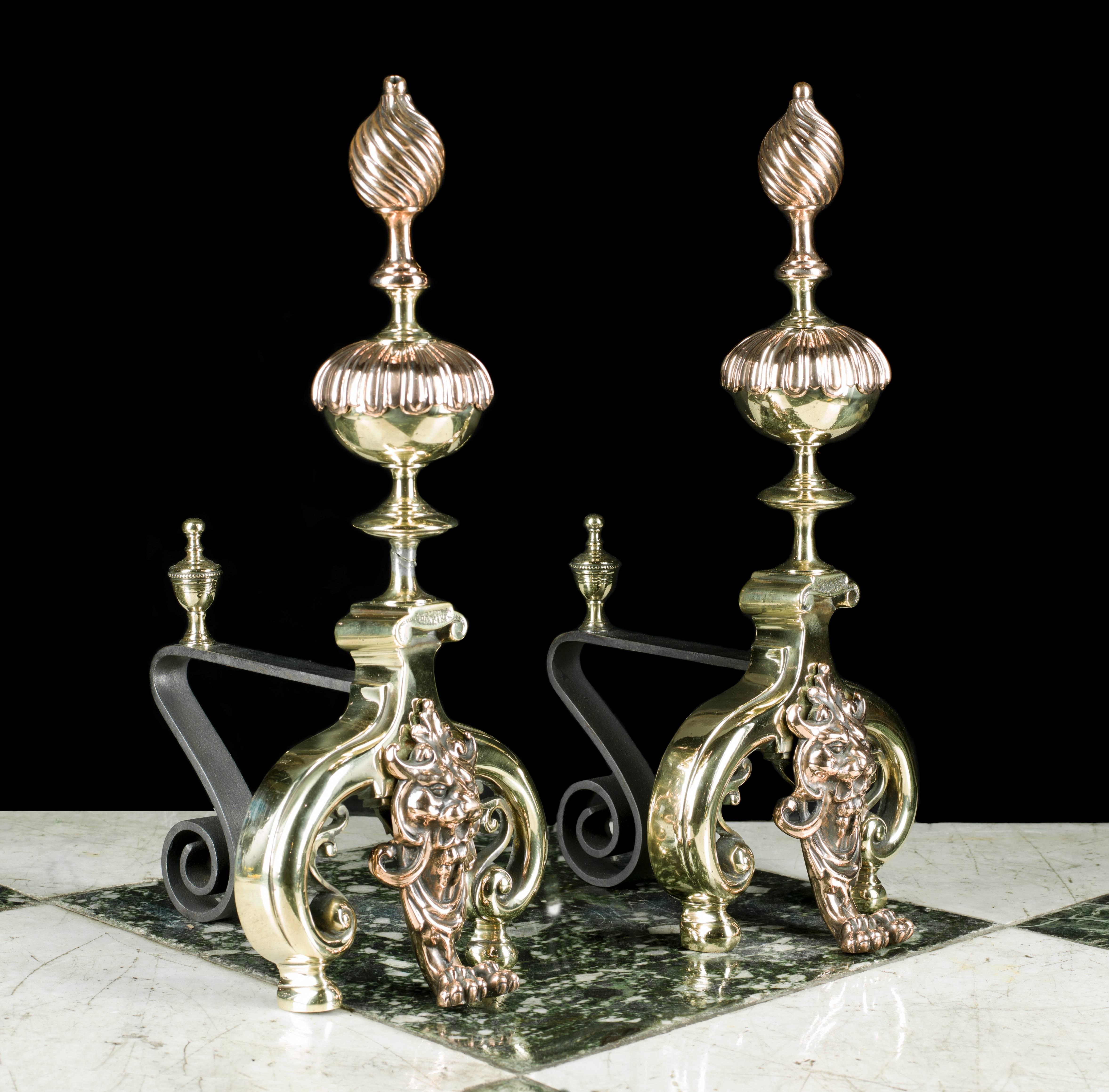 A pair of tall Louis XIV Baroque style copper and brass firedogs, with a pair of urn finials and bulbous wrythen stems above mythical lion masks flanked by sturdy curled feet,
French, 1880s.
 