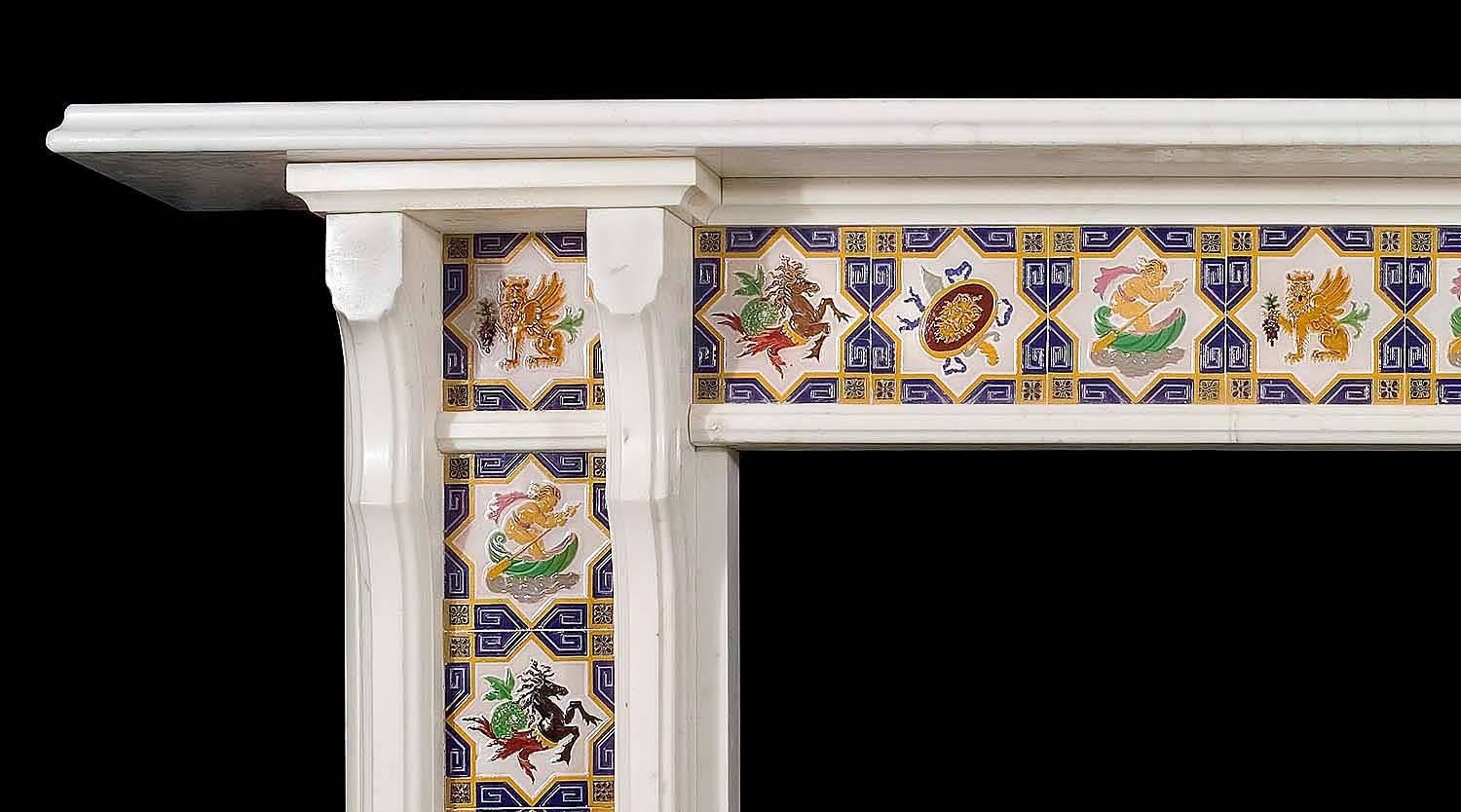 A striking Victorian fireplace mantel in white Statuary marble. It is decorated with 17 Minton Majolica tiles, five depicting winged heraldic lions holding grapes, three black and one brown prancing horses, four putti rowing in shell boats, and four