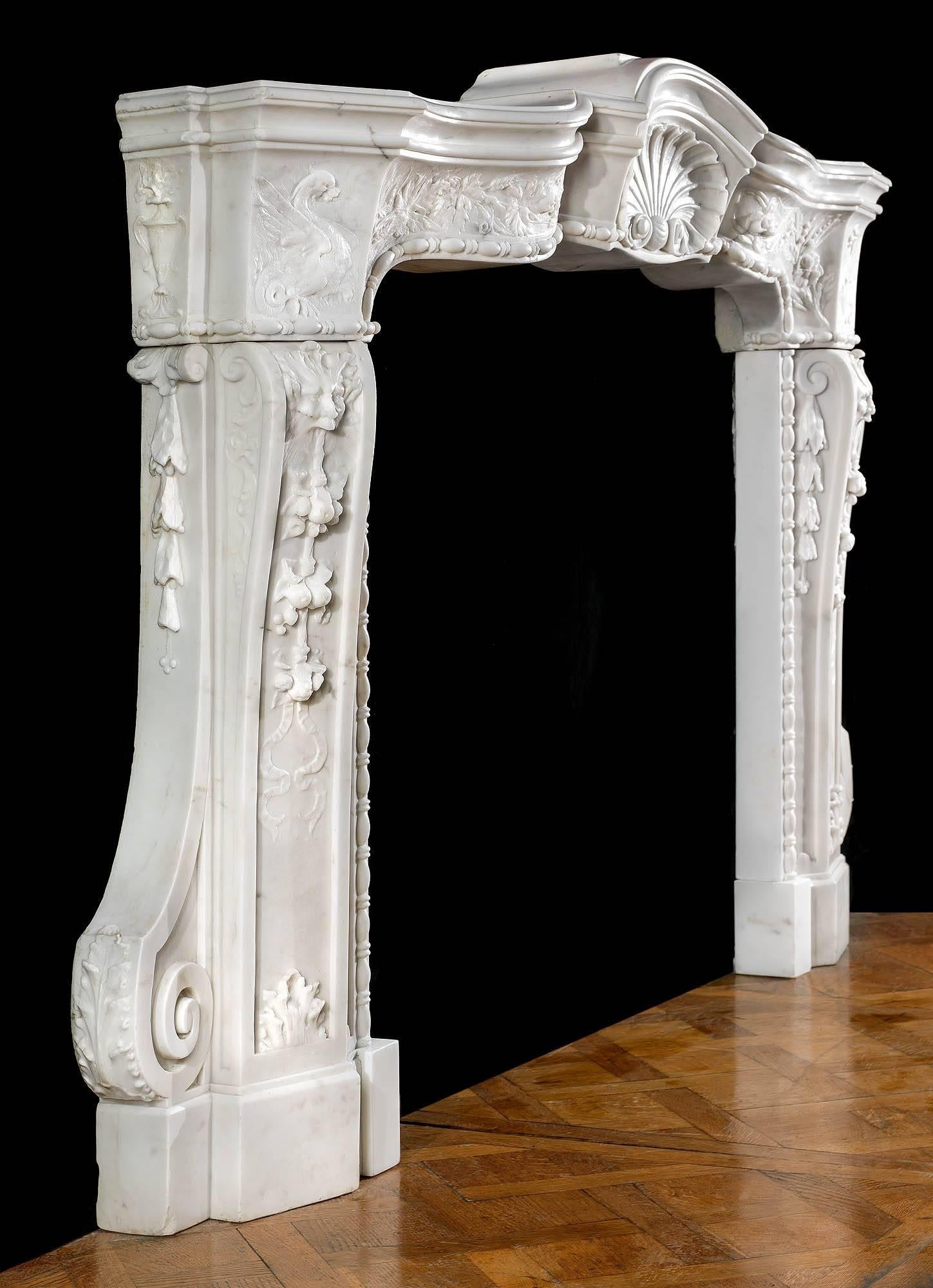 A rare 18th century Italian Baroque fireplace mantel in finely carved statuary marble. The generously moulded arched shelf forms the upper part of a serpentine frieze which extends the full width of the mantel and is centred by a high prominent