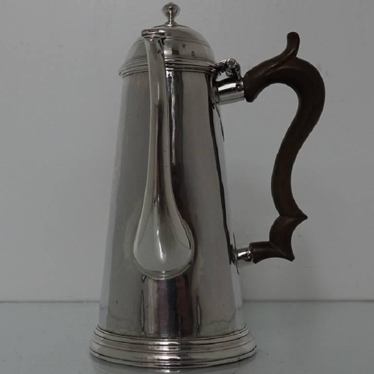 A stunningly beautiful and highly collectable side handled coffee pot with plain formed tapering body with a contemporary coat of arms for importance. The scroll designed fruitwood handle has elegant heart shaped cut card work applied around the