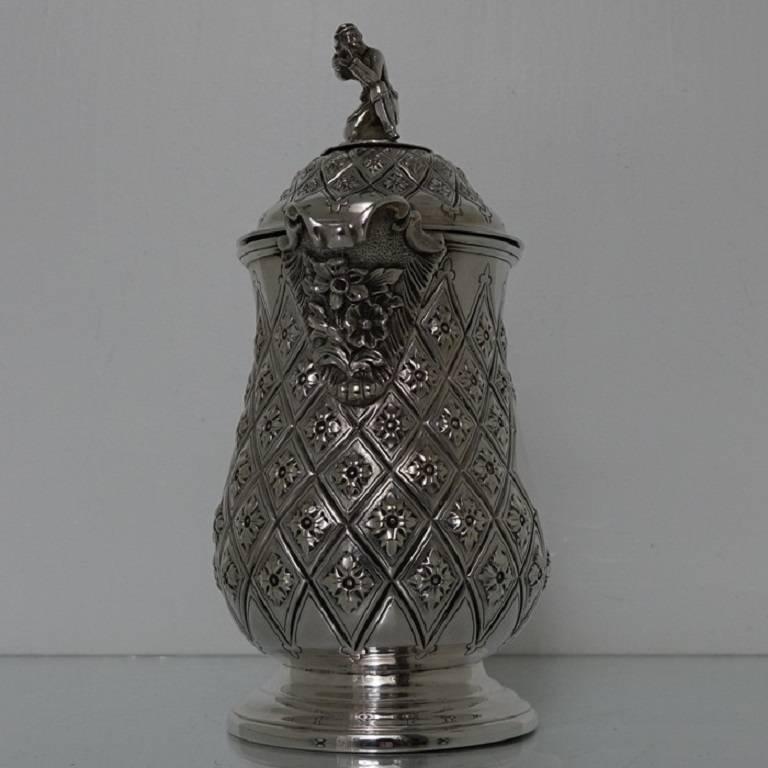 A very elegant Victorian plated Abercrombie patterned beer/wine flagon with single scroll handle. The body of the flagon has a very stylish diamond shaped double cartouche and is crowned with a domed hinged lid with a delightful soldier finial.