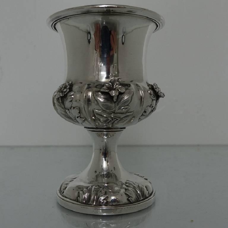 A very stylish and extremely good quality William IV wine goblet with floral embossing and applied rosette decoration. The central upper part of the bowl is shaped in plain tapering form under which sits an ornate gallery. The foot is raised