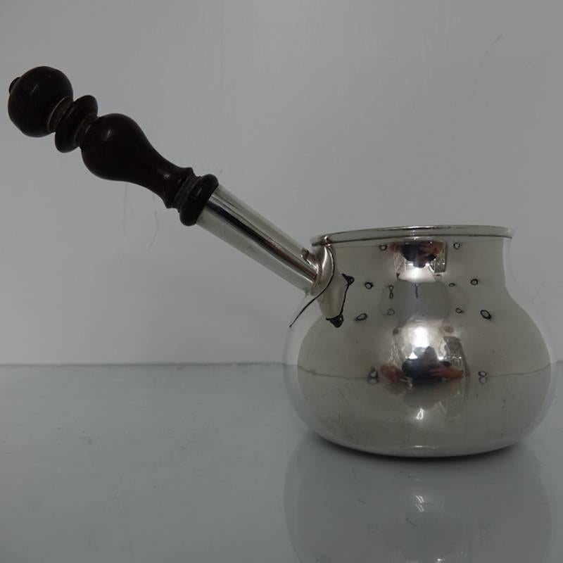 An extremely beautiful large George I plain formed baluster brandy pan with decorative fruitwood handle. The bowl of the brandy pan is elegantly formed with an incorporated stylish spout. It is of very good quality. Measures: Weighing 17 ounces and