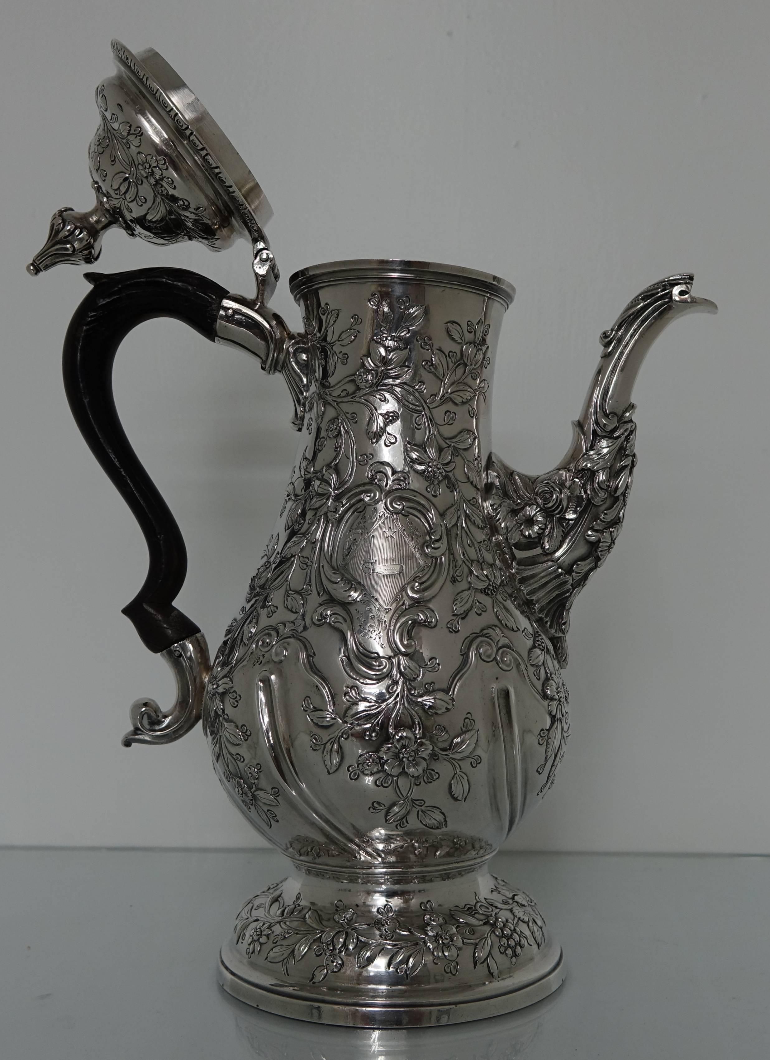 Georgian Silver 18th Century Rococo Coffee Pot London 1769 Charles Wright

A large elegant George III Rococo coffee pot with pristine grape and vine hand chased workmanship throughout with a cartouche incorporating a family crest.  The coffee pot