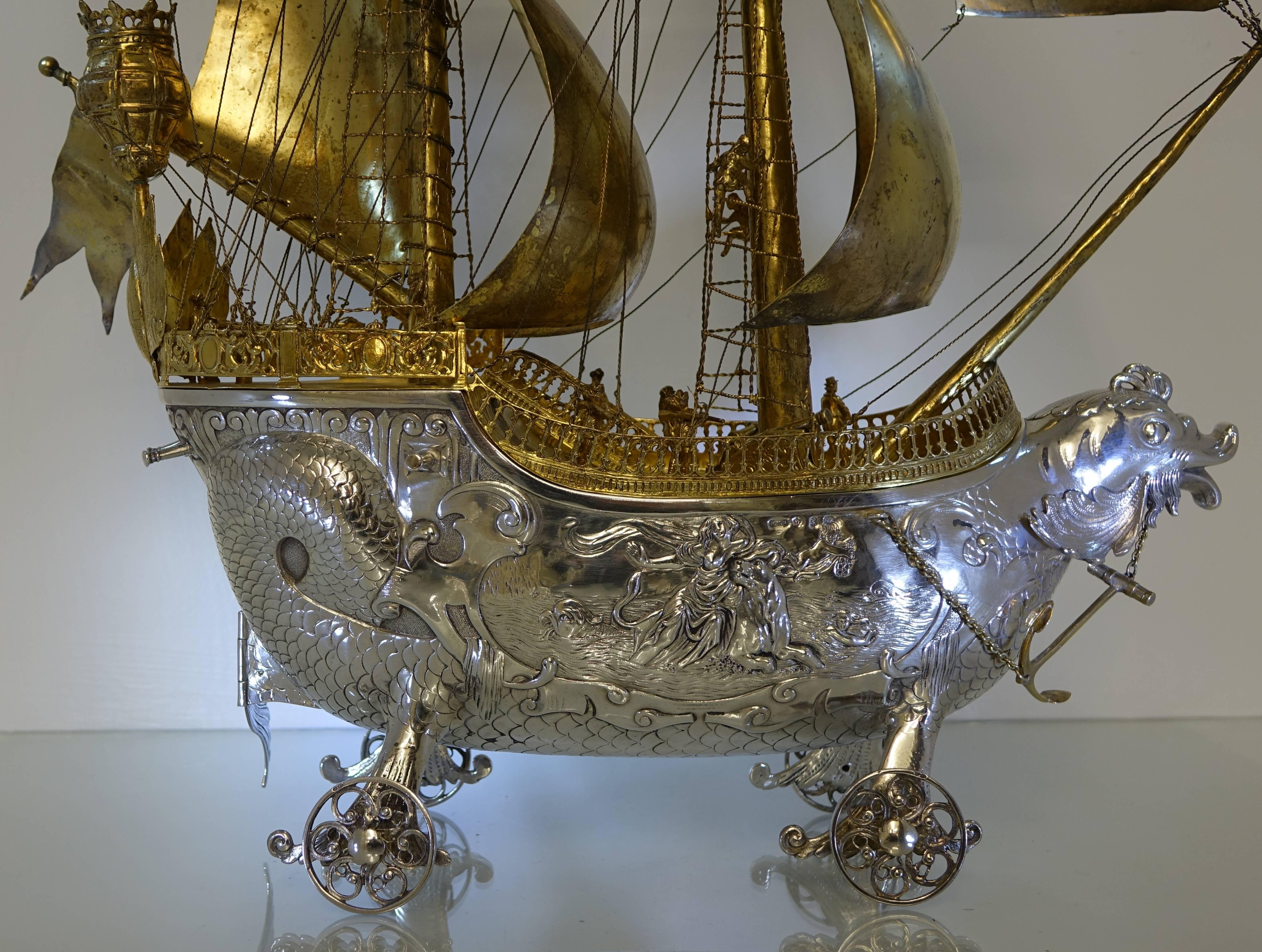 Antique silver Neff/Galleon import marks 1913 Berthold Muller.

A stunningly beautiful large silver Neff/Galleon with ornate hand chasing depicting life at sea. The hull of the Neff has a serpent theme throughout with the bow baring a serpent’s