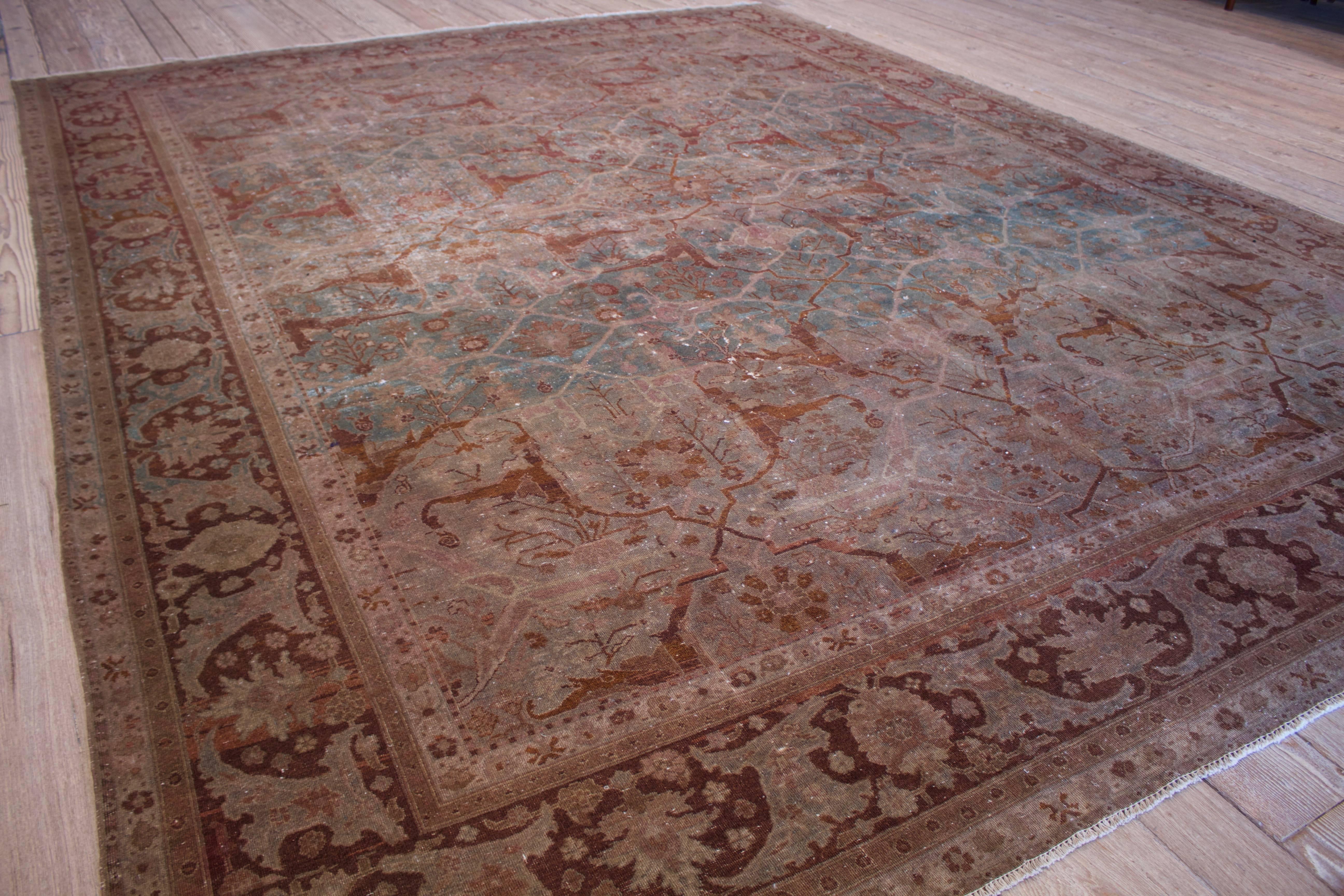 Distressed green and red antique Agra rug. This is an all-over antique Agra with garden imagery. Measures: 10'10" x 14'.