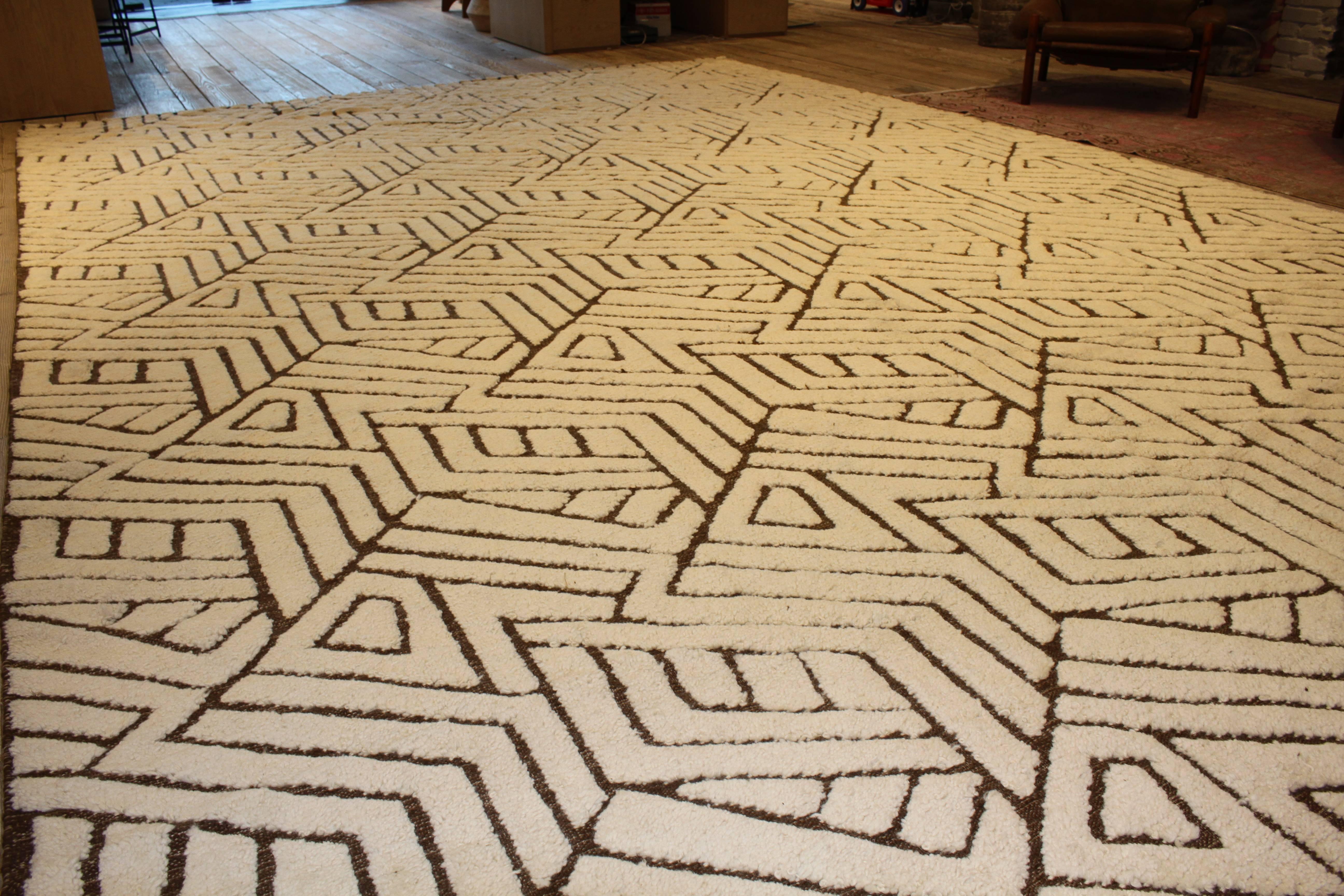 A Moroccan style rug with all-over geometric patterned design. Measures 120” x 168’.