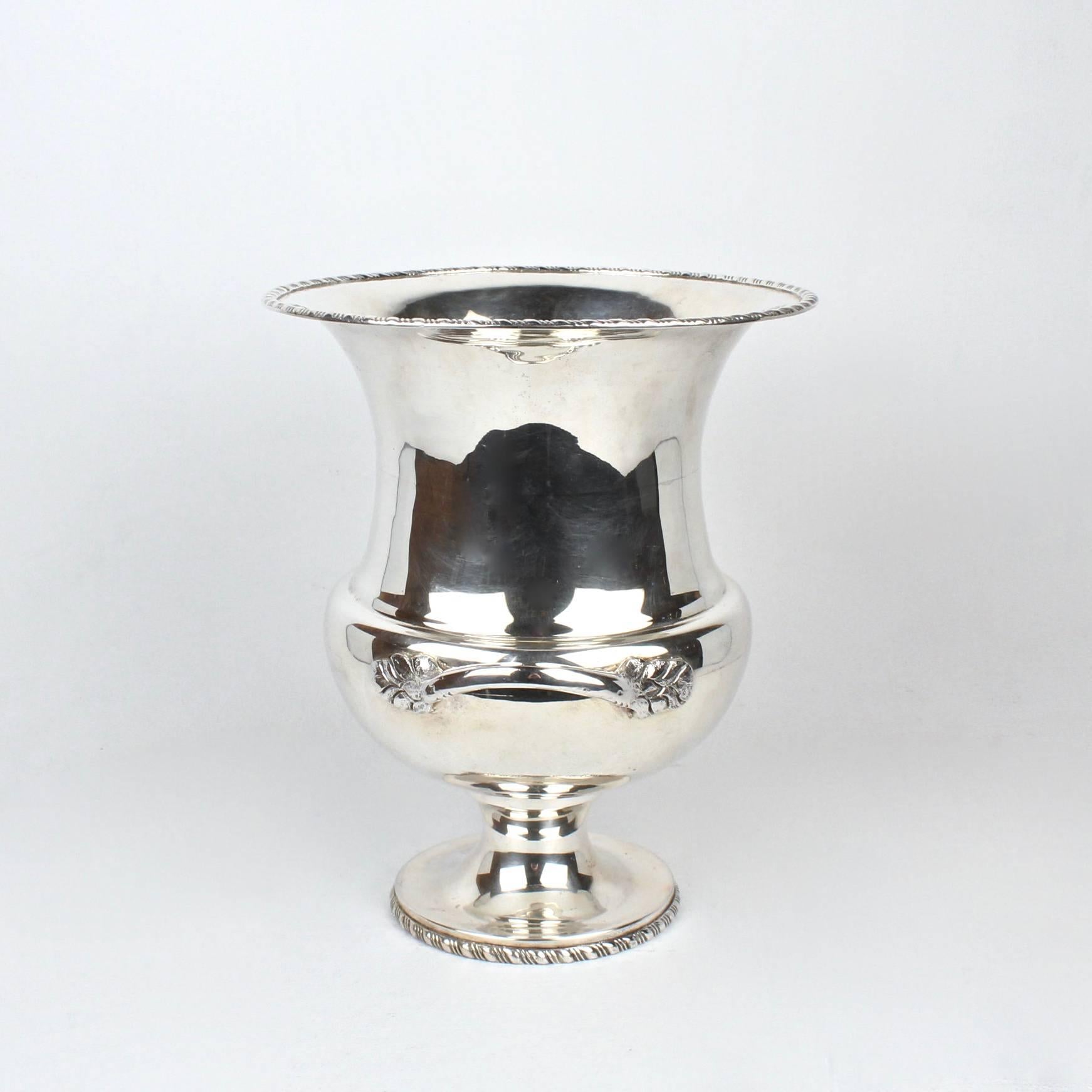 A large (and heavy) solid Mexican sterling silver champagne cooler or wine bucket.

As with much of Mexican silver, this champagne cooler has a slightly rustic feel. It has several wonderful signs of hand construction, including two visible seams